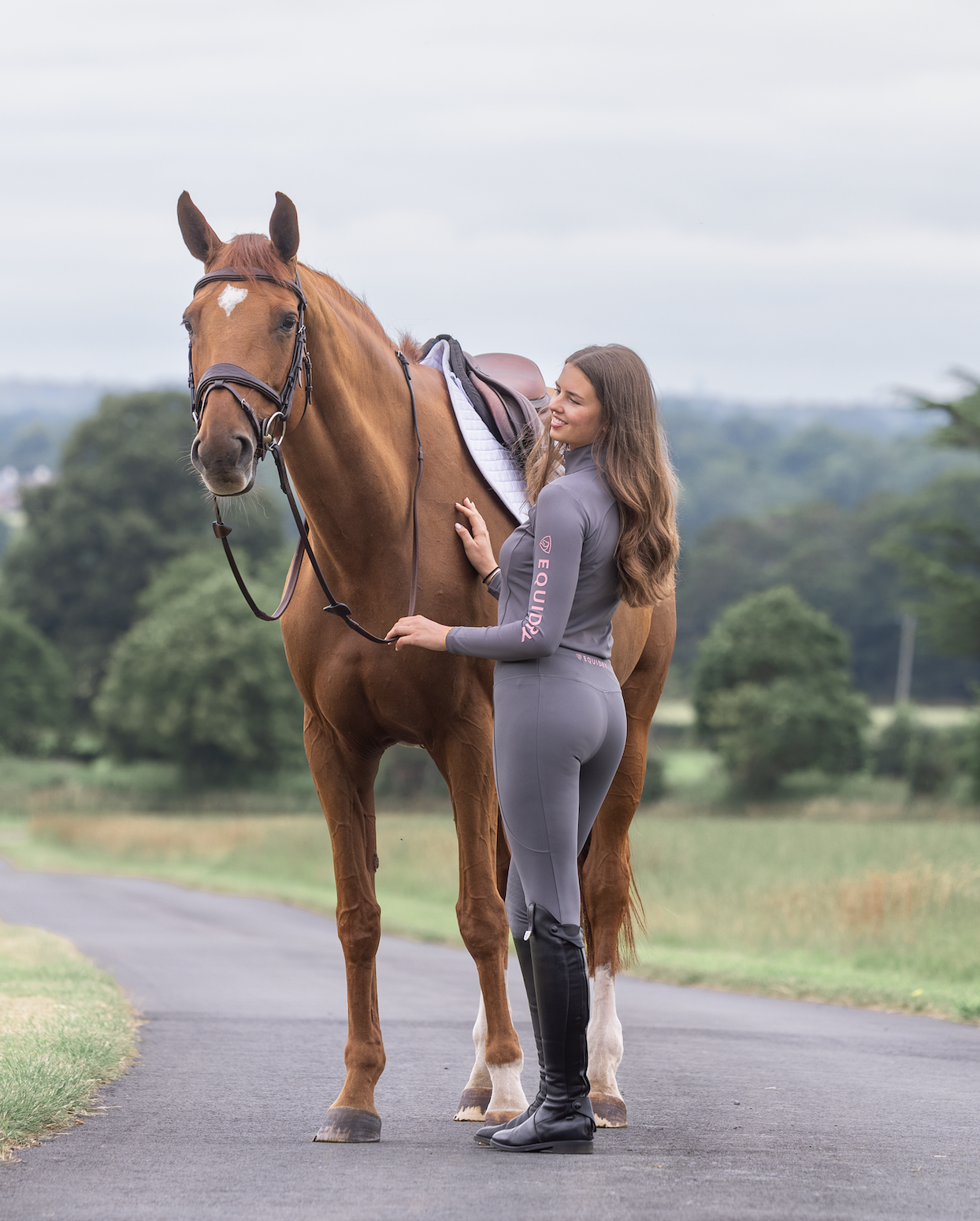 Equestrian with Horse wearing EQUIDRY leggings - Grey/Pink Water Repellent Riding Leggings for Women by Equiflair
