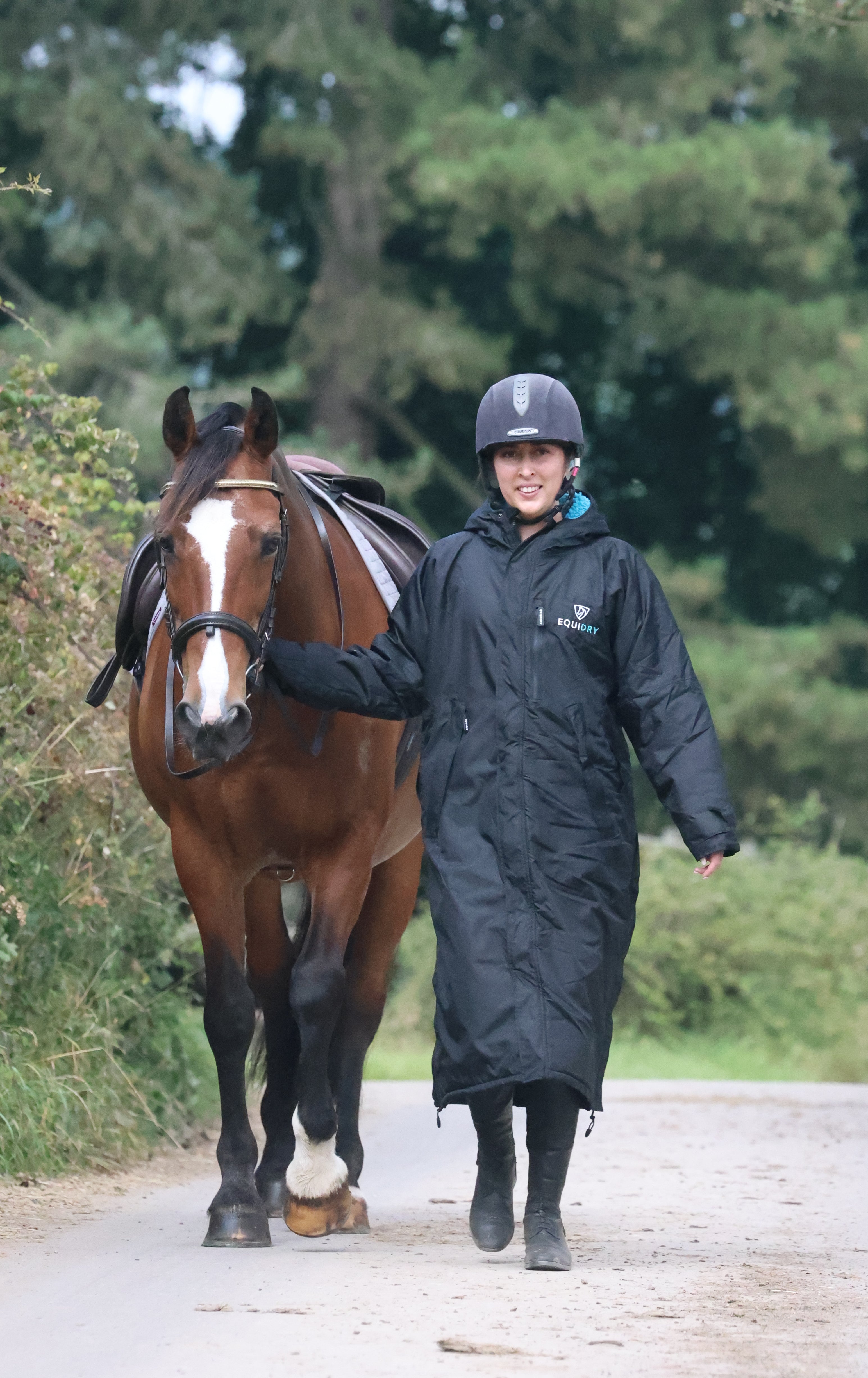 EQUIDRY Women's Black Waterproof Riding Coat with Horse. Equestrian apparel, weatherproof riding wear.