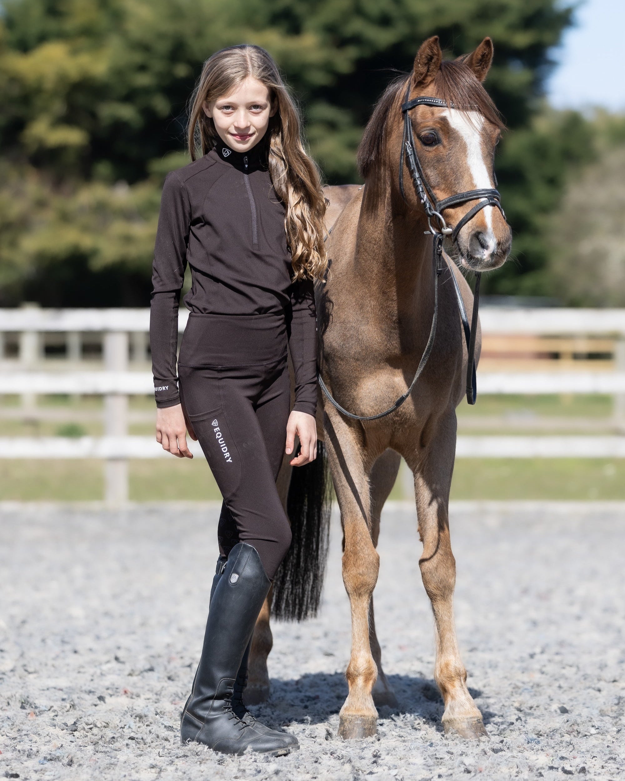 Girl with pony wearing Equidry Equestrian Base Layer - Children's horse riding apparel Equiflair