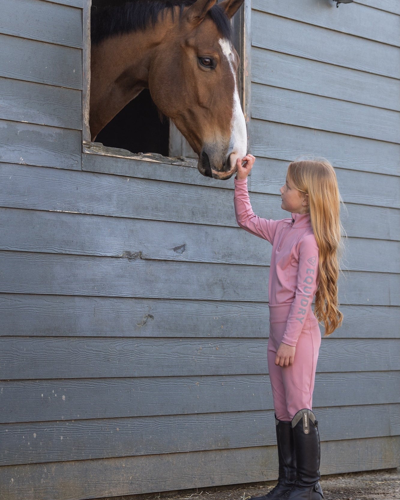 Girl in Pink Equestrian Outfit Feeding Horse at Stable | Child and Horse Bonding Moment | Equiflair