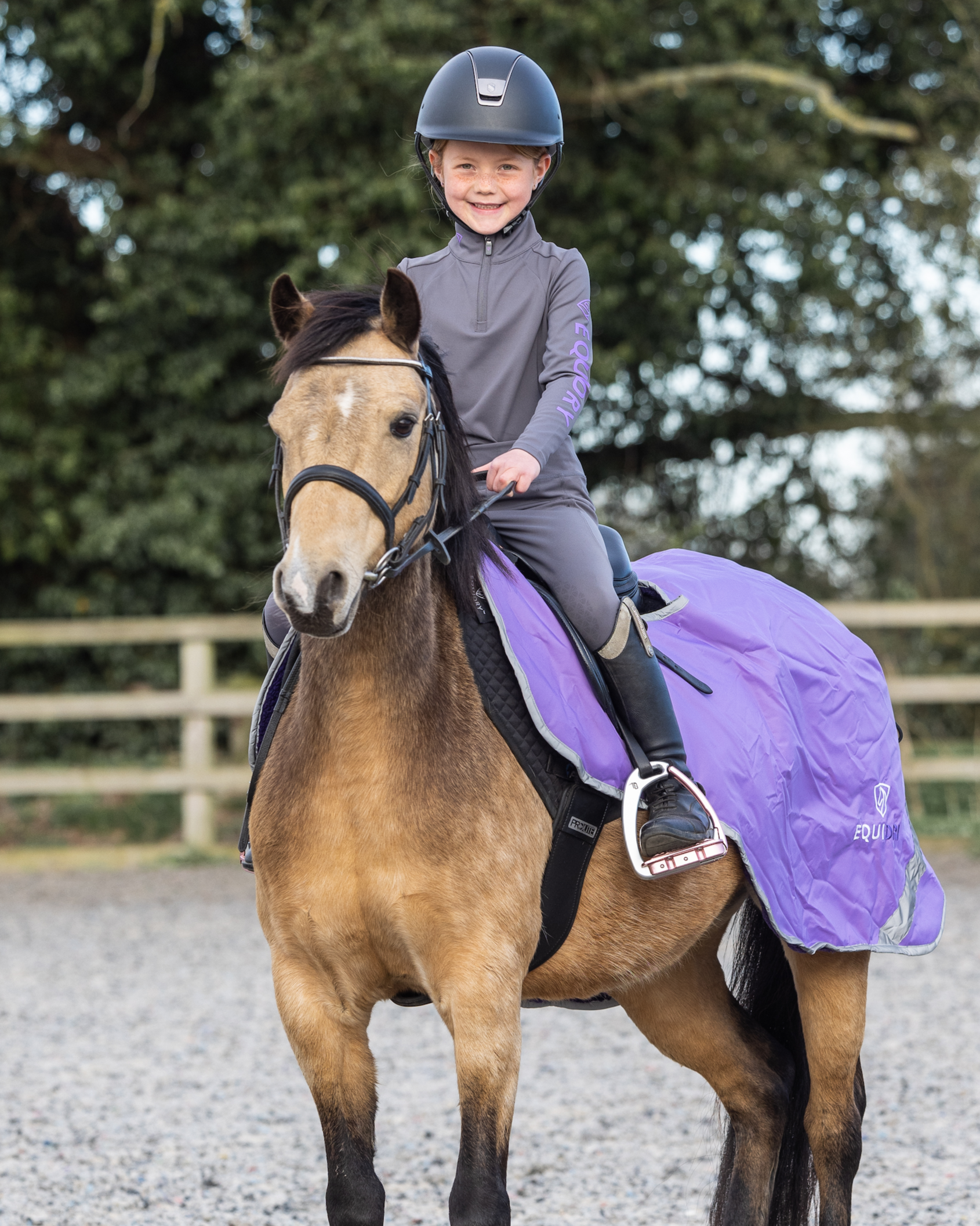 Child rider on horse wearing Equidry equestrian base layer grey/lilac, Equiflair. Equestrian clothing, horse riding gear, kids.