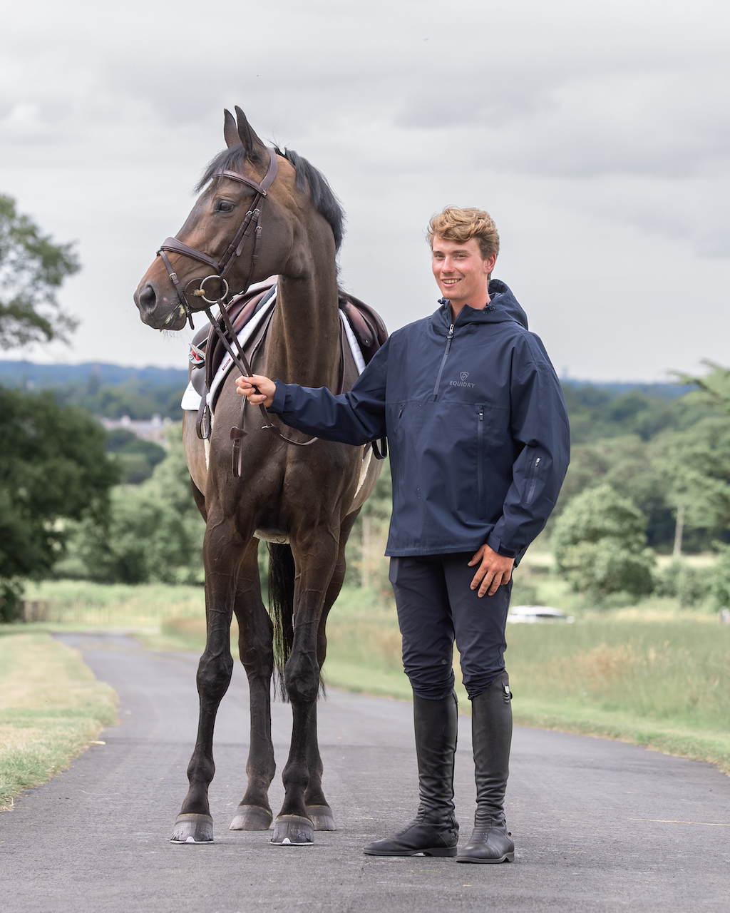 Equidry Men's Storm Smock: Waterproof horse riding jacket in navy. Rider and horse