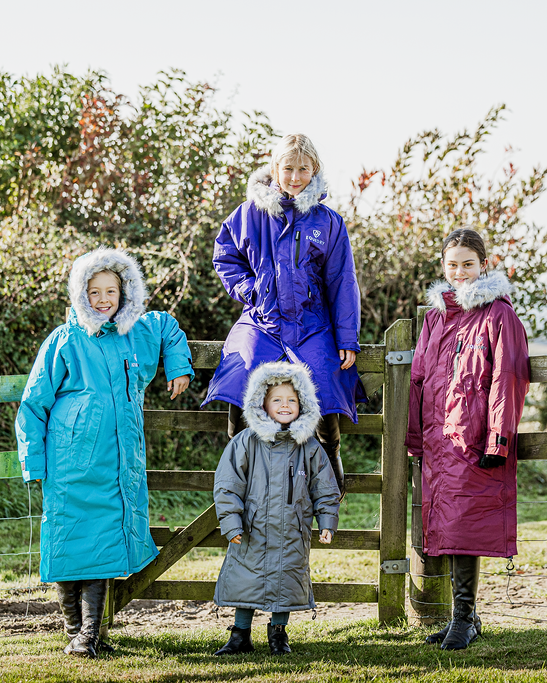 EQUIDRY Evolution Lux children's Warm Waterproof Winter Horse Riding Coat Thick Fleece Lining with Faux Fur Trim Hood being shown in purple, turquoise, plum/ charcoal/grey
