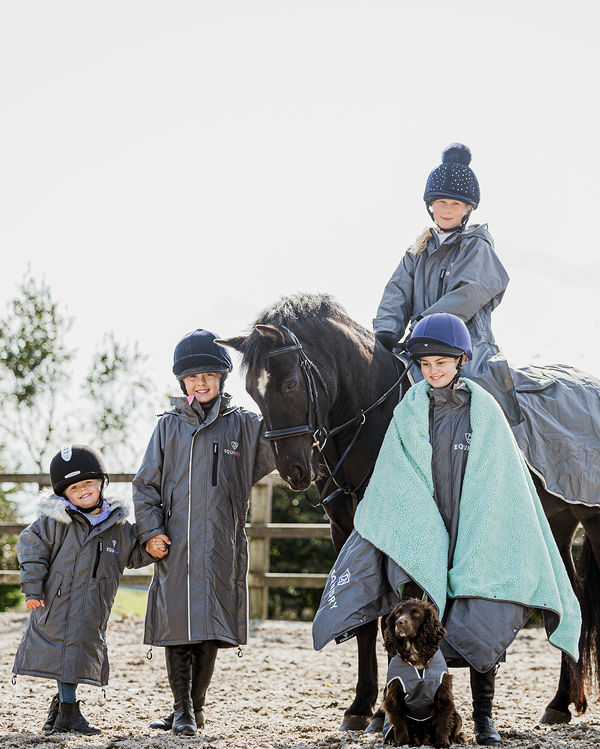 EQUIDRY waterproof horse riding raincoat thin fleece pro ride reflective in charcoal/pale pink children's grey family photo in arena