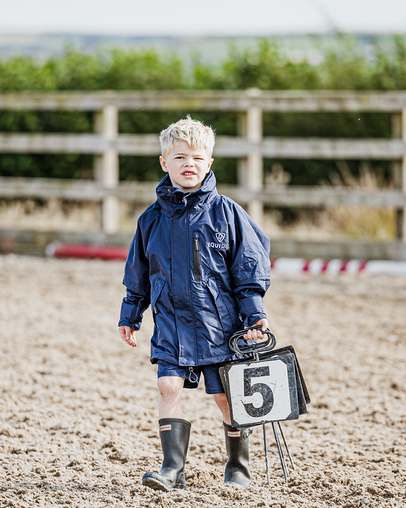 Shortie Child's Oversized Short Waterproof blouson style Riding Jacket Thin Fleece Lining Stowaway Hood in navy/navy kid in arena