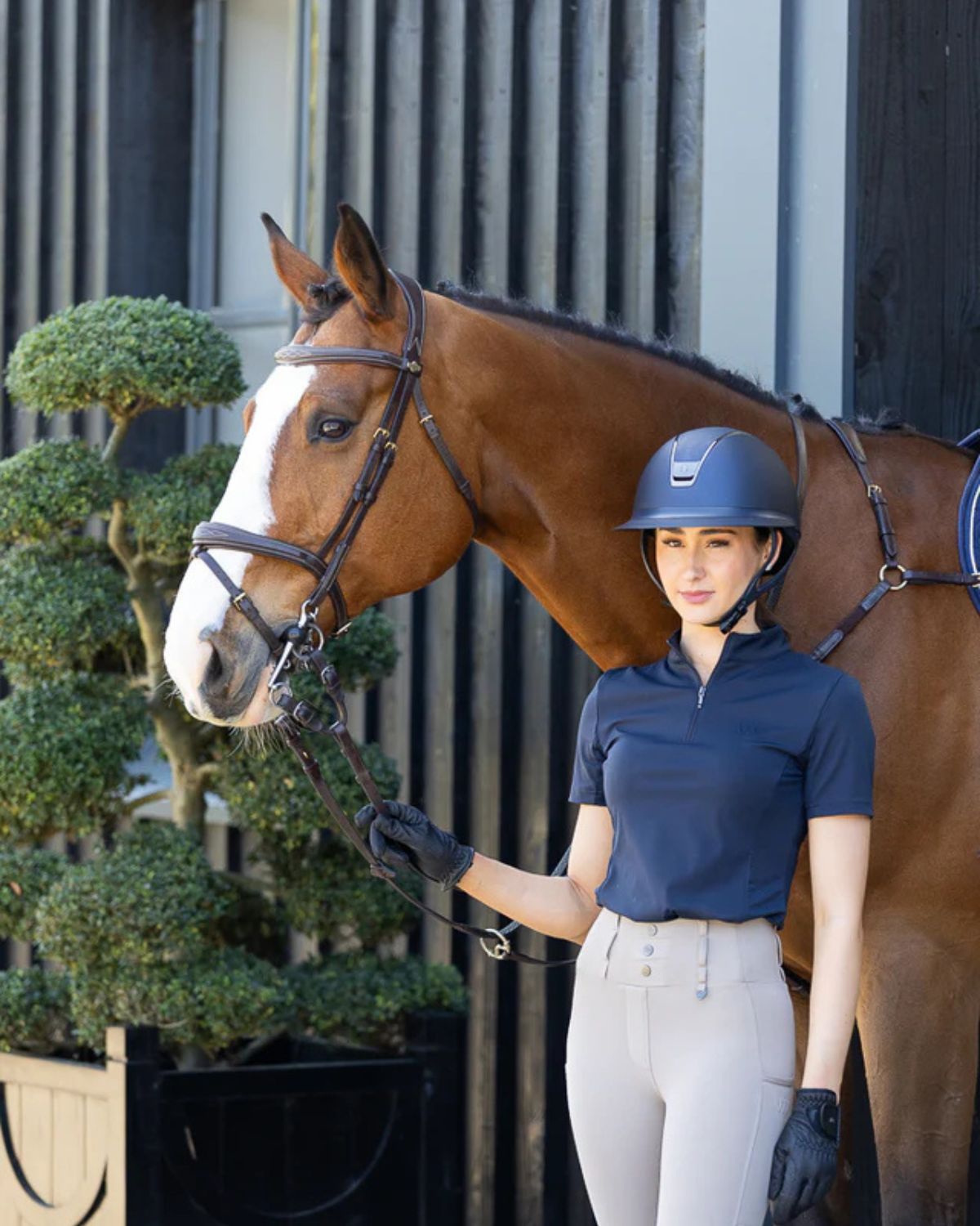 Equestrian: Woof Wear Navy Riding Shirt. Woman with Horse. Technical Horse Riding Apparel. Equiflair.