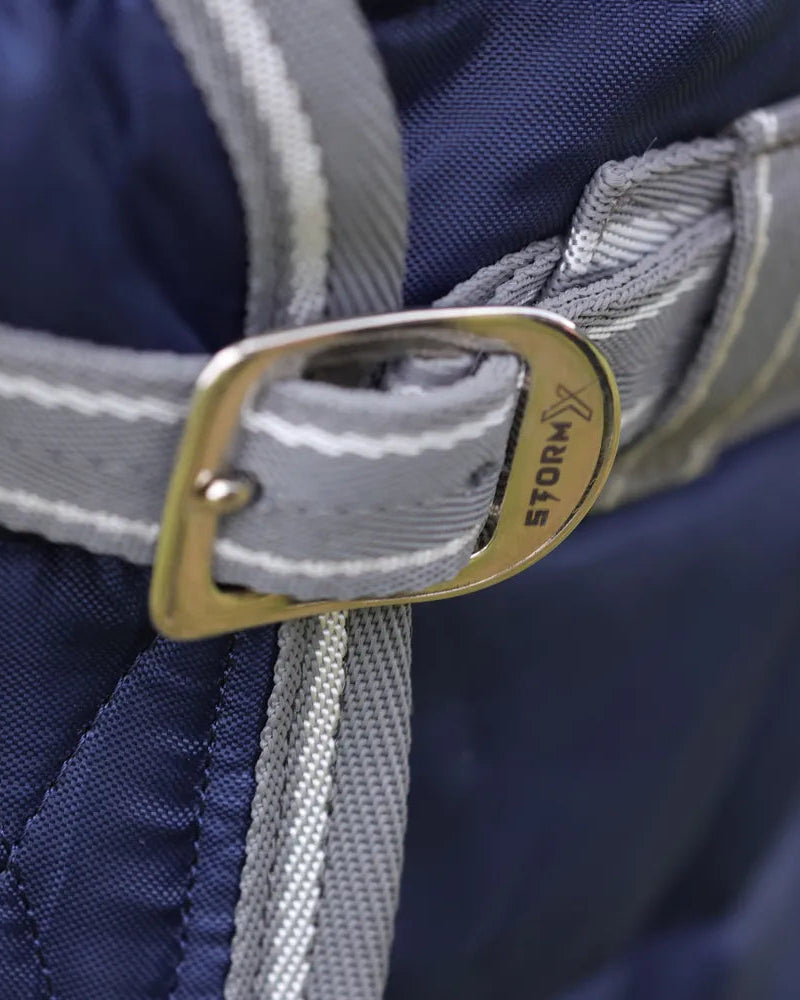 StormX Empra 100 Stable Rug - Navy from Equiflair: Close-up of Buckle & Strap. Durable Horse Rug for Cooler Days, Stable Use
