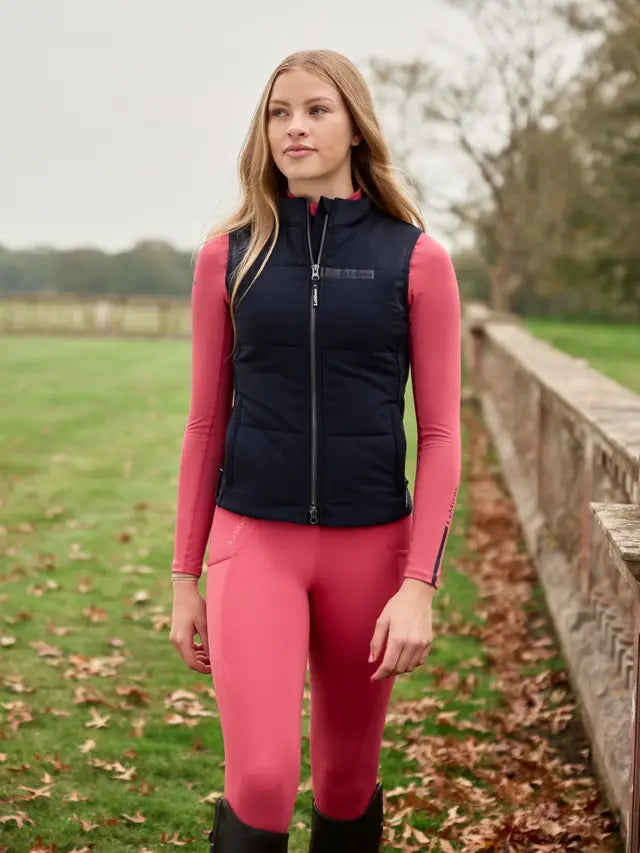 Lemieux Young Rider Pammy Training Gilet Navy - Equiflair: Stylish girl in riding attire, navy vest.