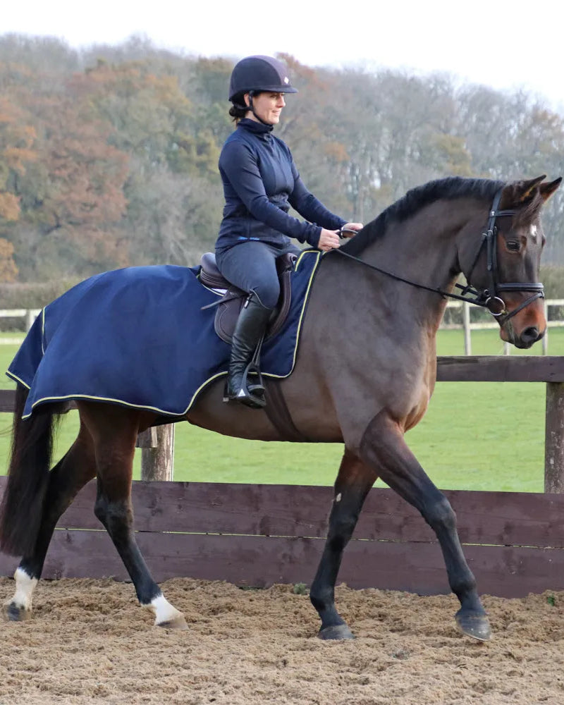 Woman Riding Horse with StormX Waterproof Exercise Sheet - Navy, Equiflair | Horse Riding Gear