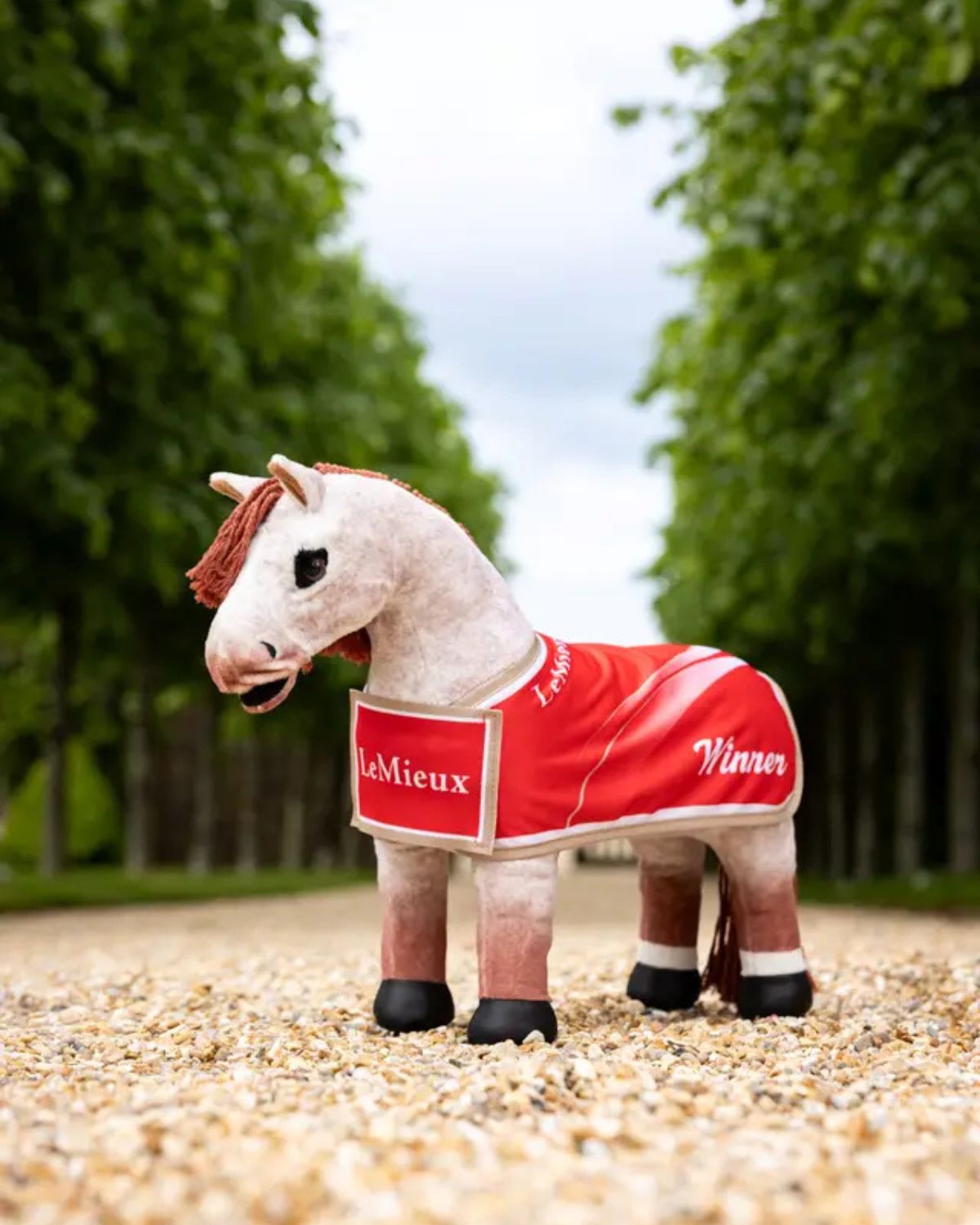 LeMieux Toy Pony Winners Rug - Red. Plush horse wearing red "Winner" blanket with logo. Equine toy accessory from Equiflair store.
