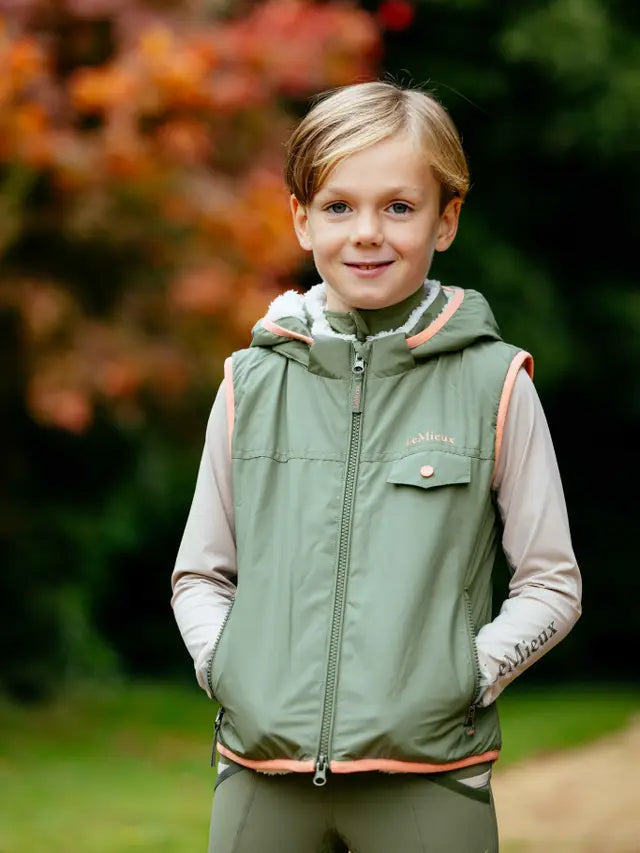 LeMieux Mini George Gilet Rosemary: Child in equestrian outerwear with sherpa fleece lining. Warm & stylish for outdoor play!