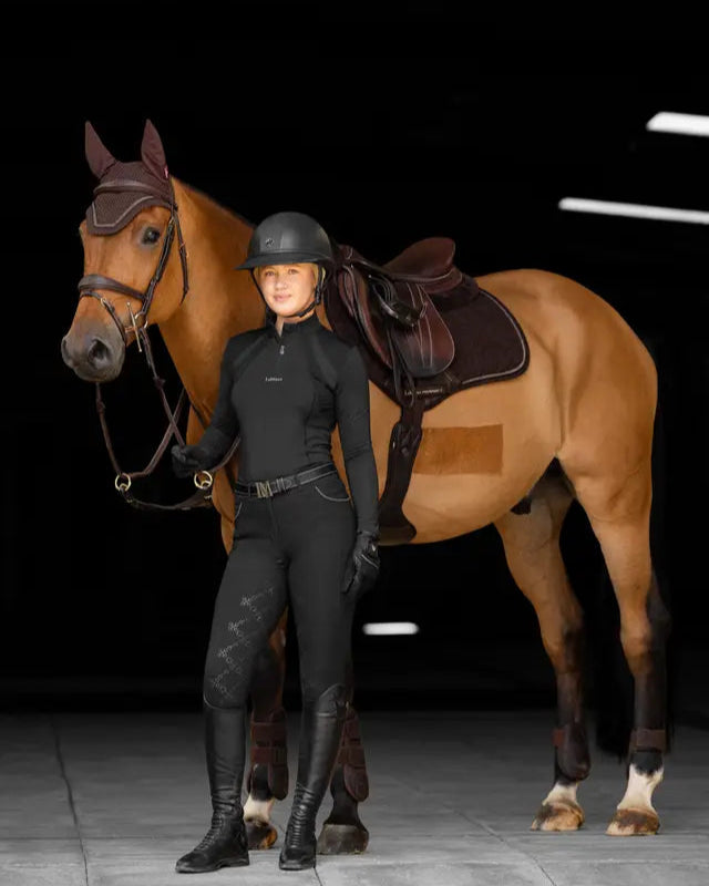 Equestrian apparel: LEMIEUX CRYSTAL SUEDE Close Contact saddle pad with rider and horse. Horse riding wear.