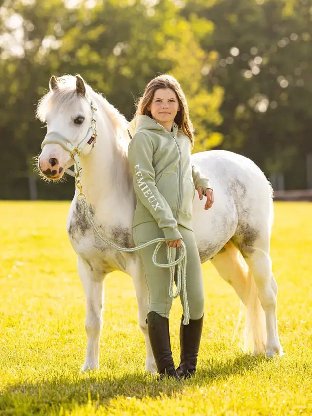 LeMieux Young Rider Heidi Hoodie Fern: Girl with pony in LeMieux equestrian apparel, perfect for young riders. #equestrianfashion