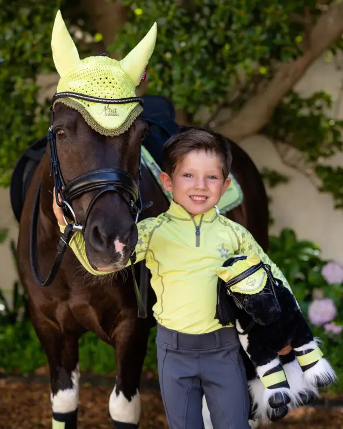 Boy with pony and LeMieux Razzle Toy Pony. Equestrian, horse, child toy. Piebald Pony