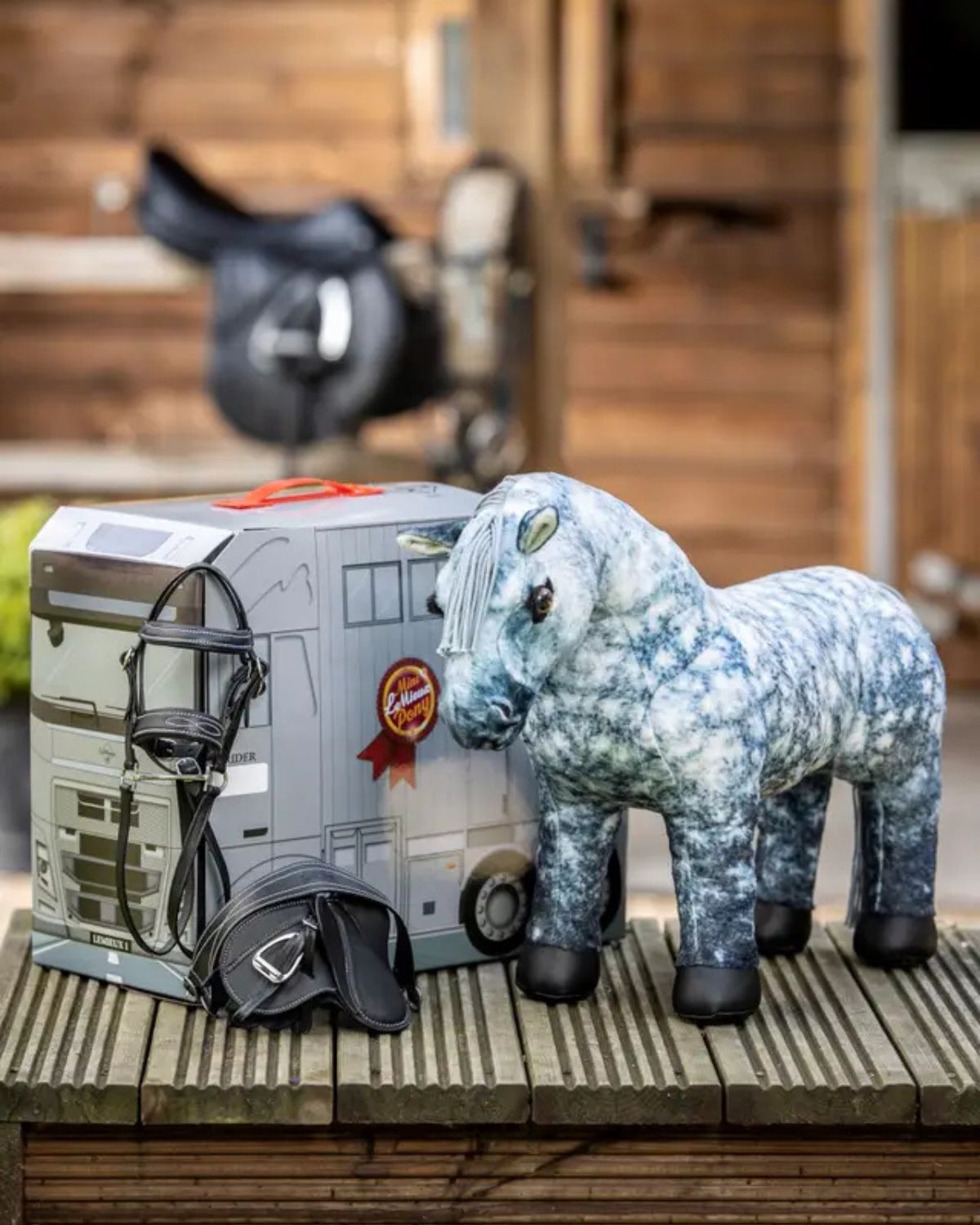Lemieux Toy Pony Sammy with horse bridle & saddle, presented in a realistic horse trailer box. Perfect equestrian toy for kids.