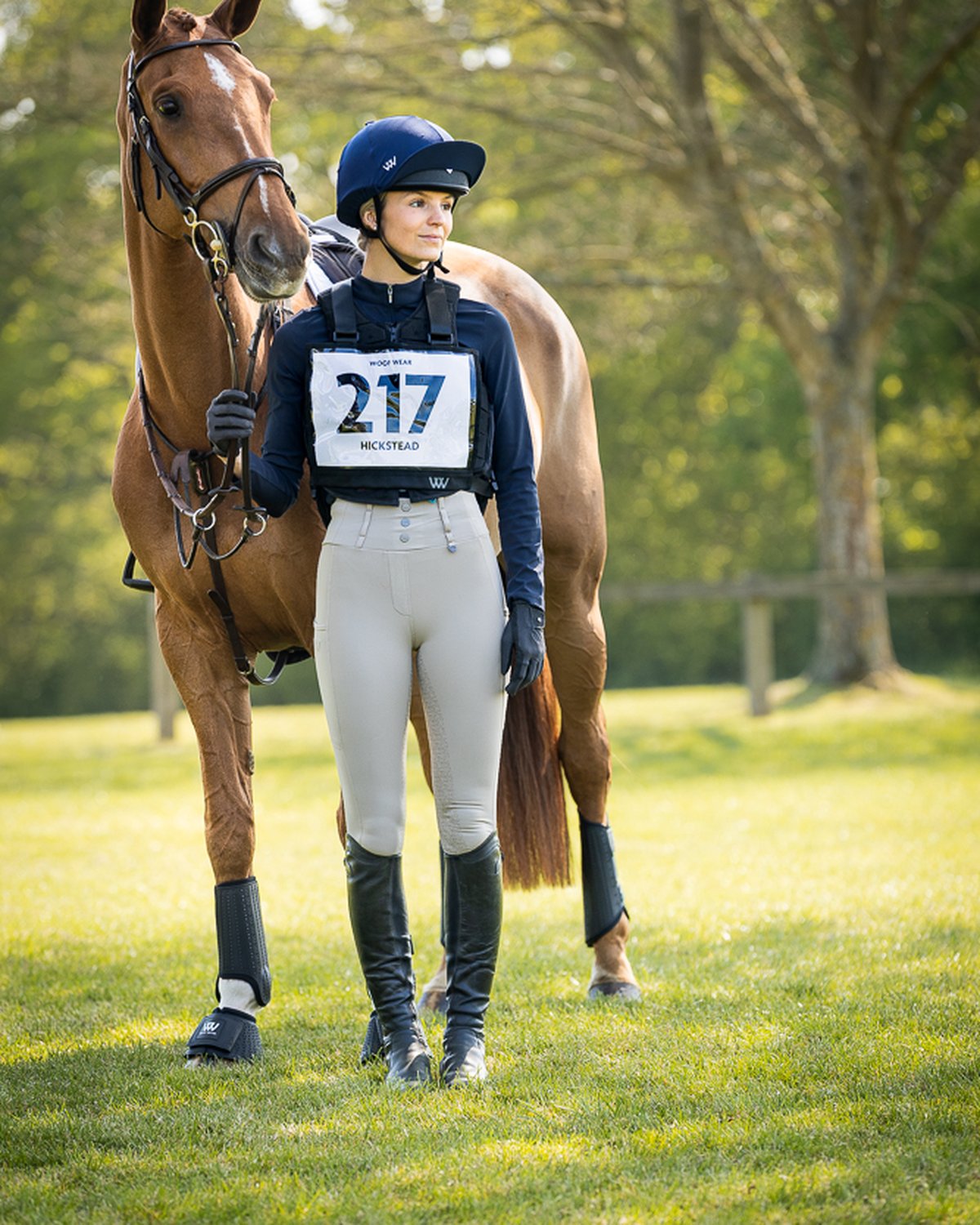 WOOF WEAR EVENT NUMBER BIB BLACK: Equestrian rider and horse at Hickstead event, wearing number 217.