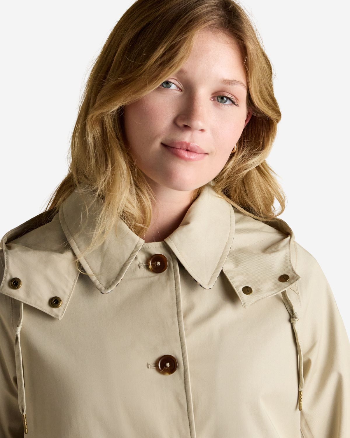 Joules Rainmore raincoat: Waterproof, button-through coat with hood and checked lining. Neutral tone.