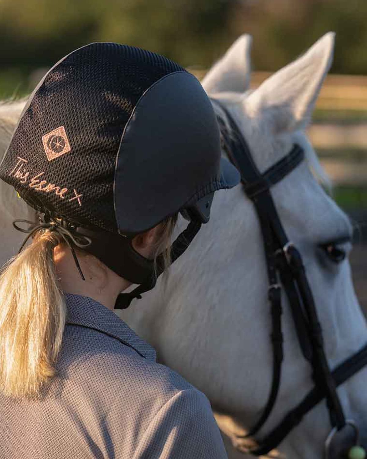 Charles Owen Esme MS1 Pro Equestrian Riding Helmet - Graphite/Rose Gold. Woman with horse. Horse riding helmet.
