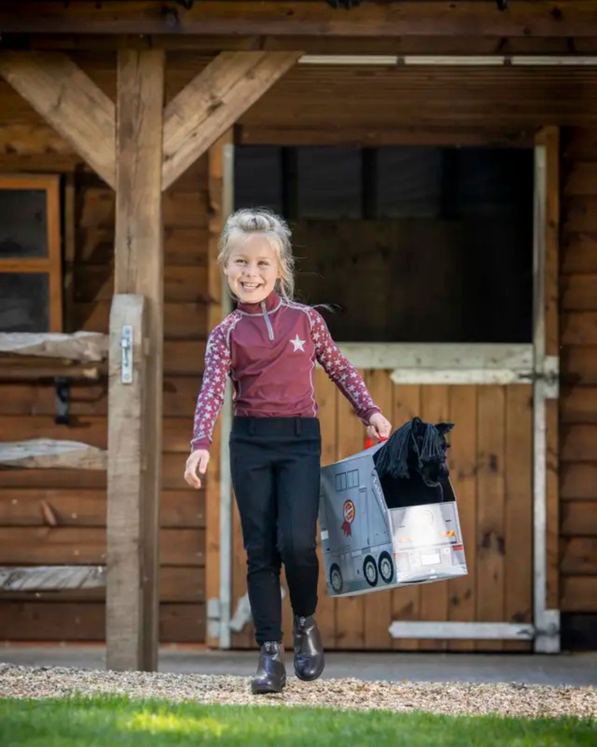 Girl with LeMieux Toy Pony Skye: Black Dressage Horse & Stable. Equiflair Store.