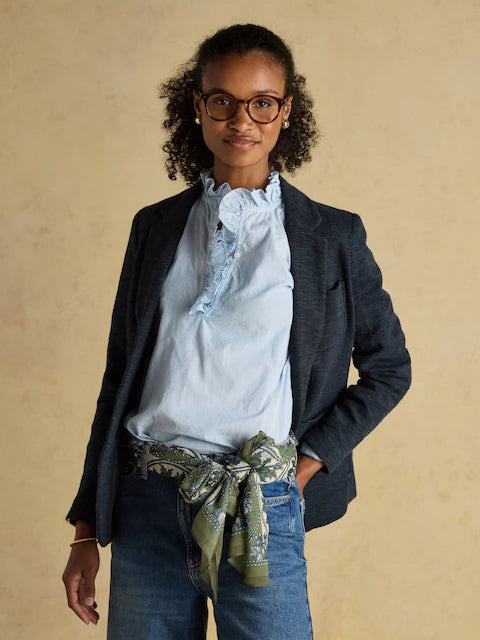 Woman wearing Joules Abberton khaki green printed scarf as belt. Lightweight stylish women's fashion accessory.
