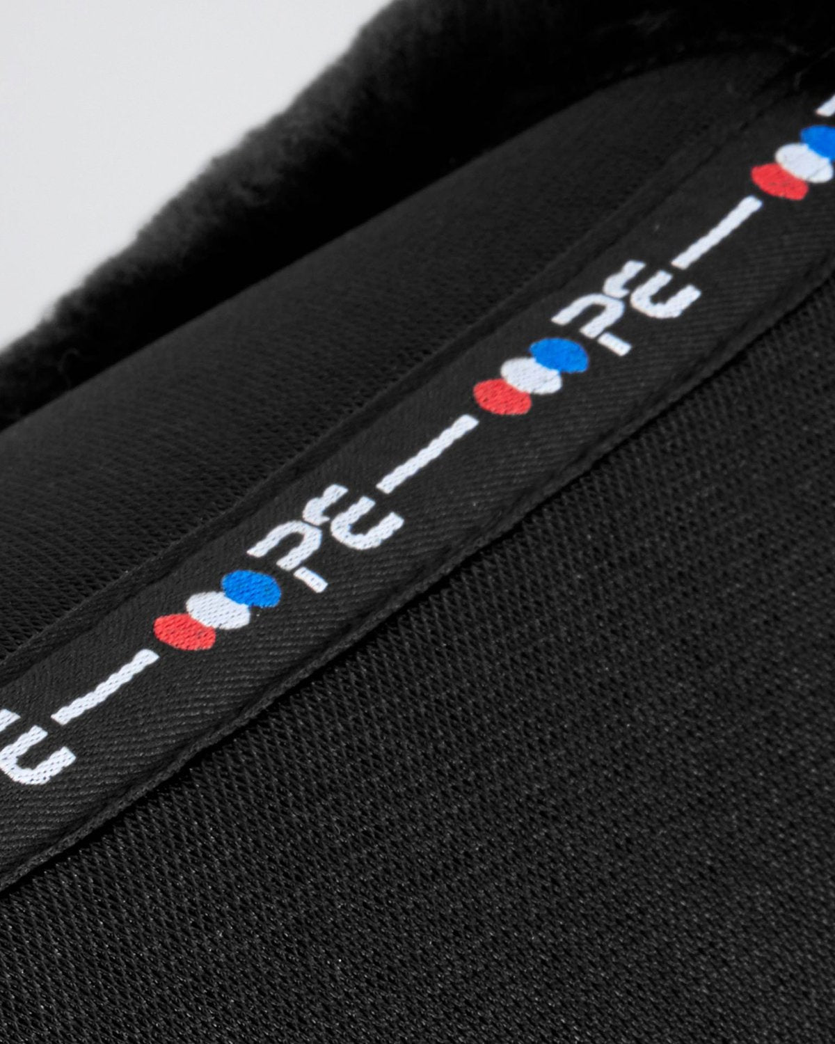 Premier Equine black wool saddle pad: Airtechnology shockproof half pad close up. Equestrian equipment for sensitive horses.