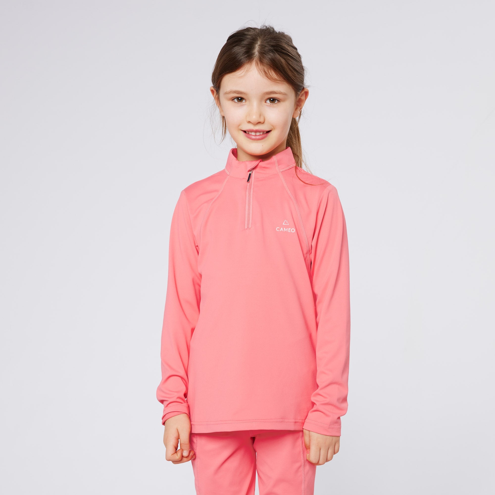 Girl in Cameo Equestrian Junior Baselayer: Comfortable Riding Apparel. Cameo Core baselayer for children.