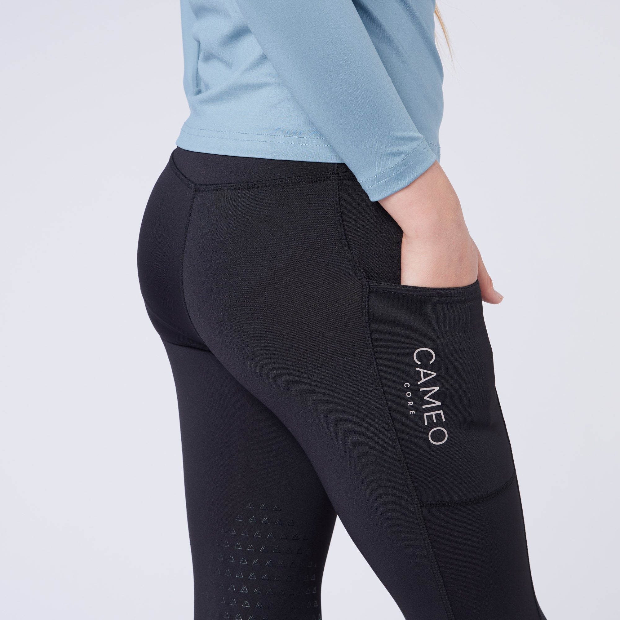 CAMEO Junior Core Riding Tights Canary: Black equestrian leggings with silicone grip, phone pocket, & 4-way stretch for kids.