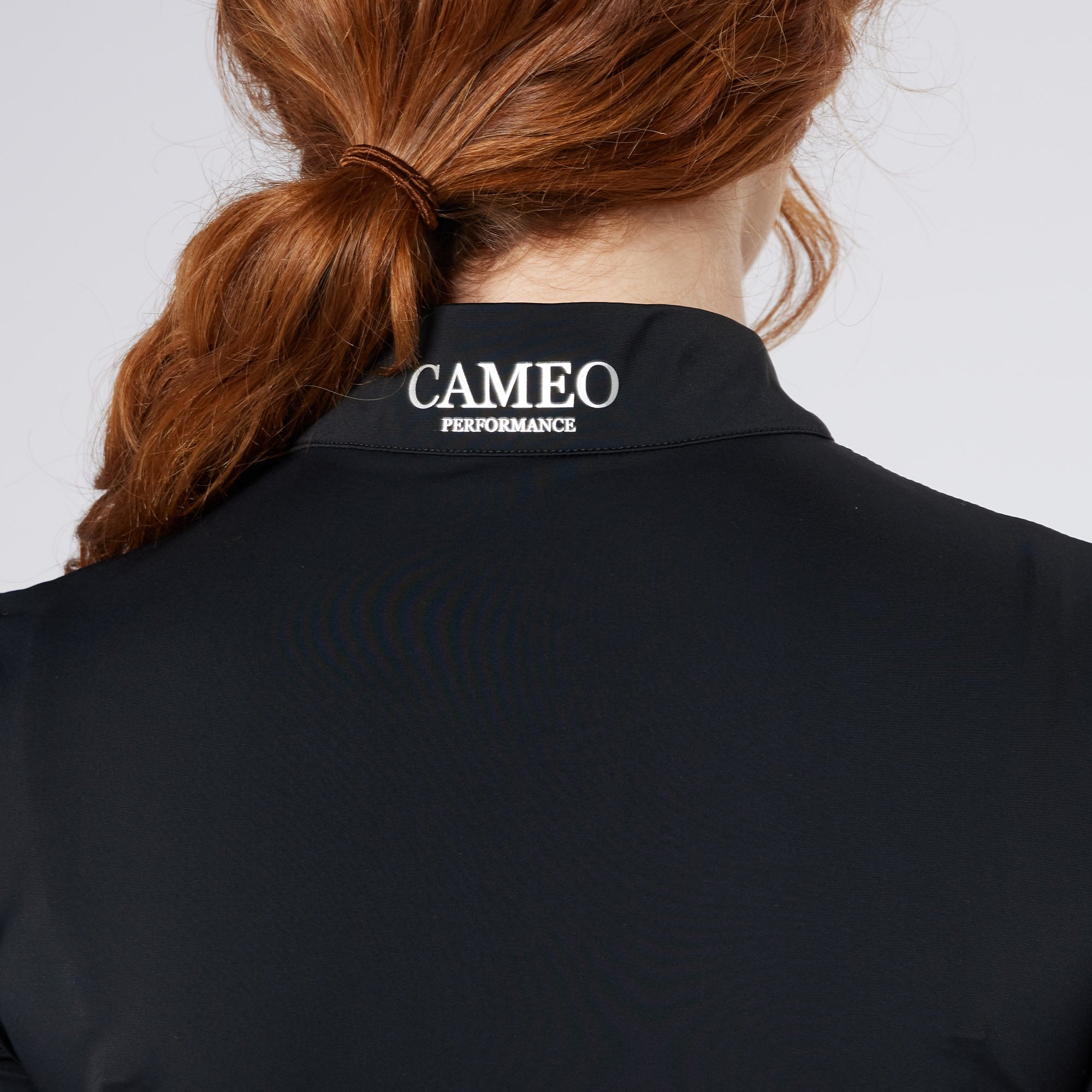 CAMEO PERFORMANCE COMPETITION SHIRT BLACK | Equiflair equestrian riding apparel shirt for women, view from back with red hair