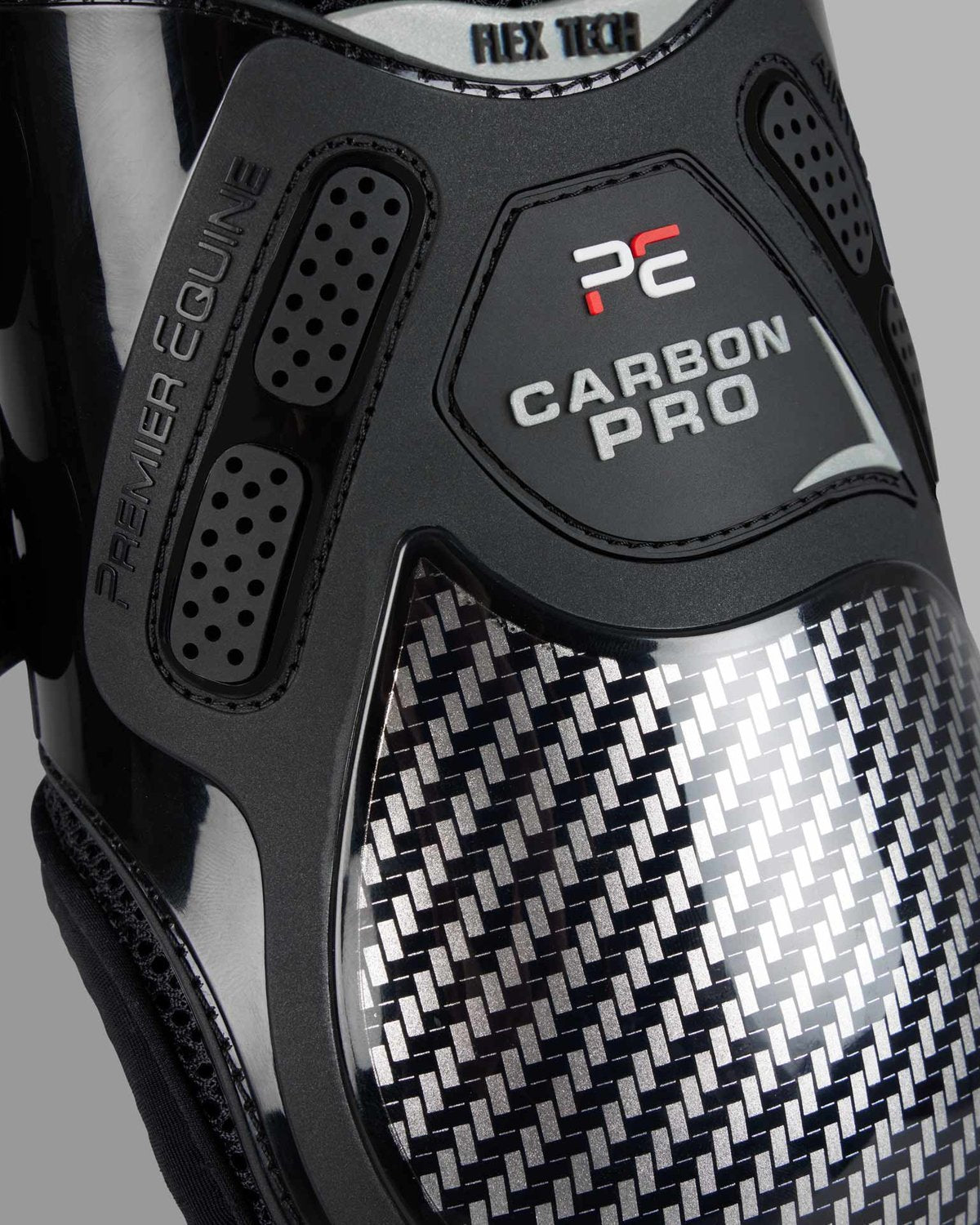 Premier Equine Carbon Pro Fetlock Boot Black: Close-up of protective equestrian legwear.