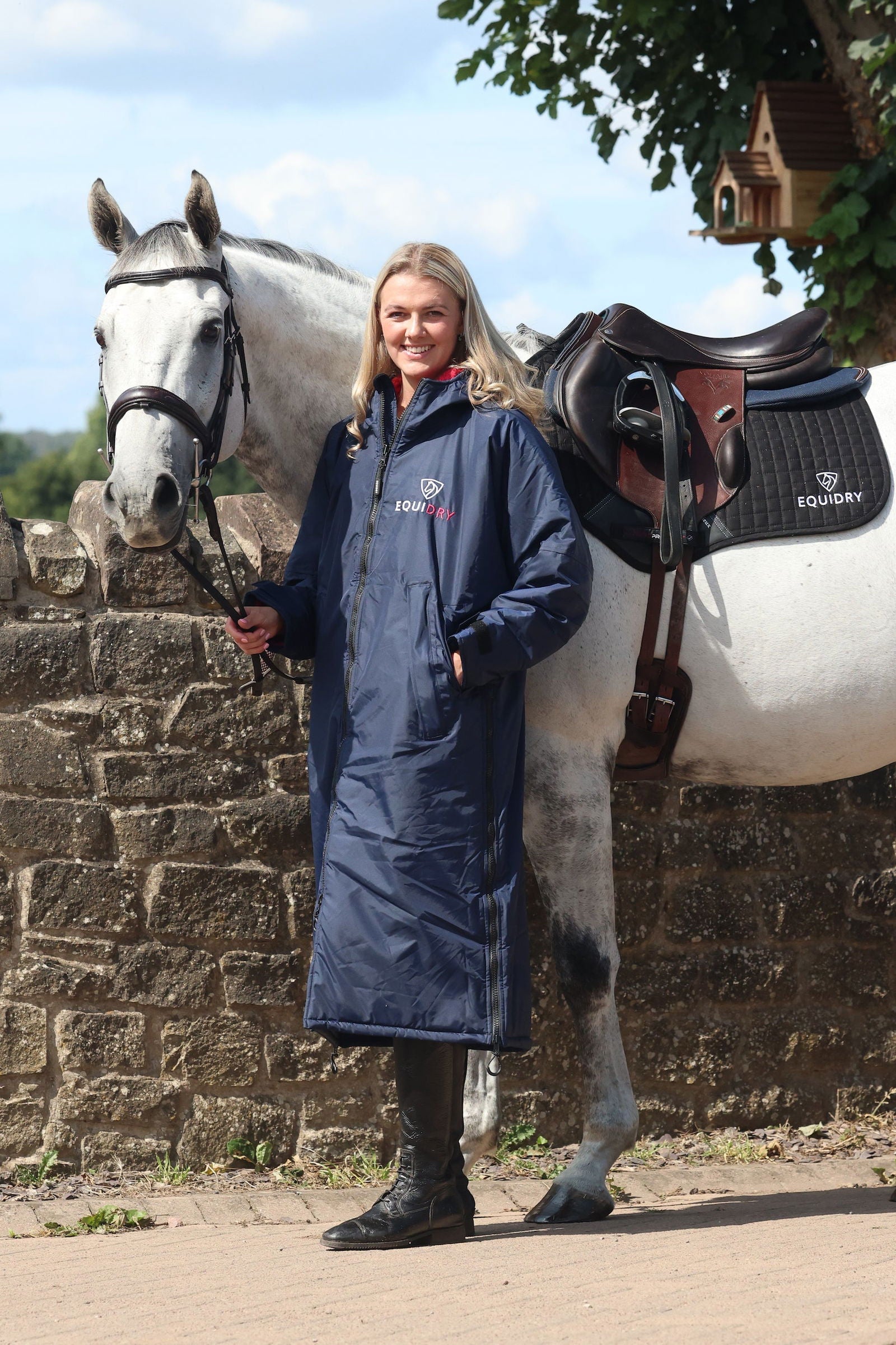 EQUIDRY waterproof horse riding raincoat All Rounder Original thick fleece Women's Navy/Raspberry full view stood with horse