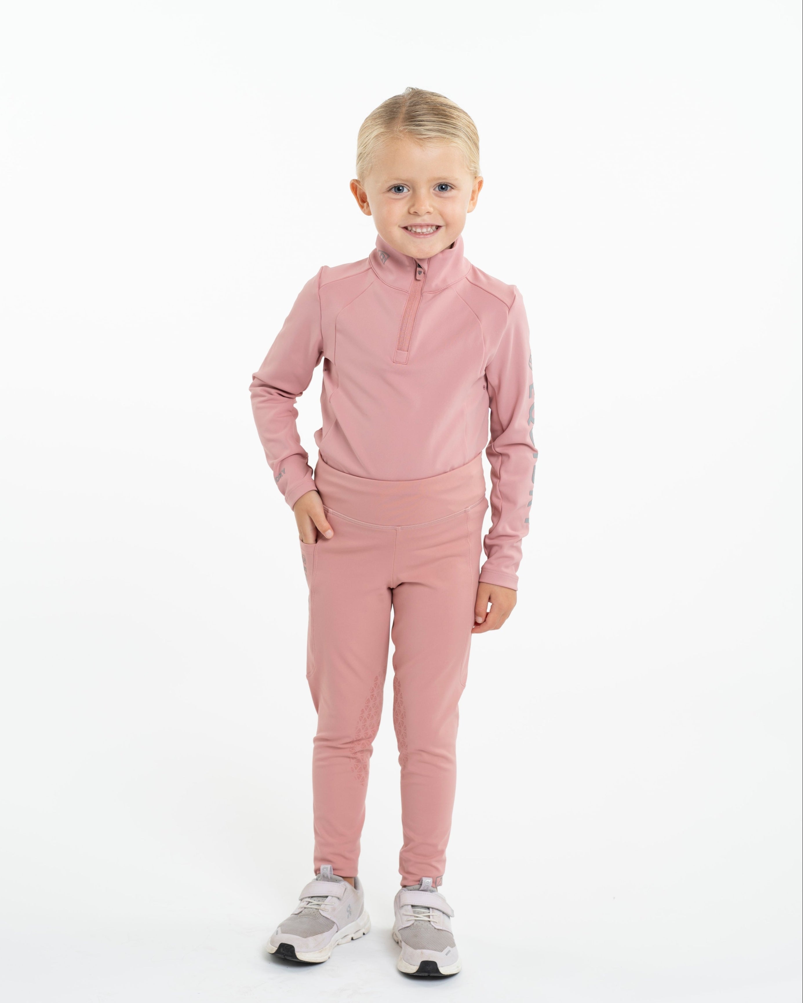 Equidry Children's Pink Water Repellent Equestrian Base Layer & Leggings by Equiflair. Young girl wearing pink horse riding clothes