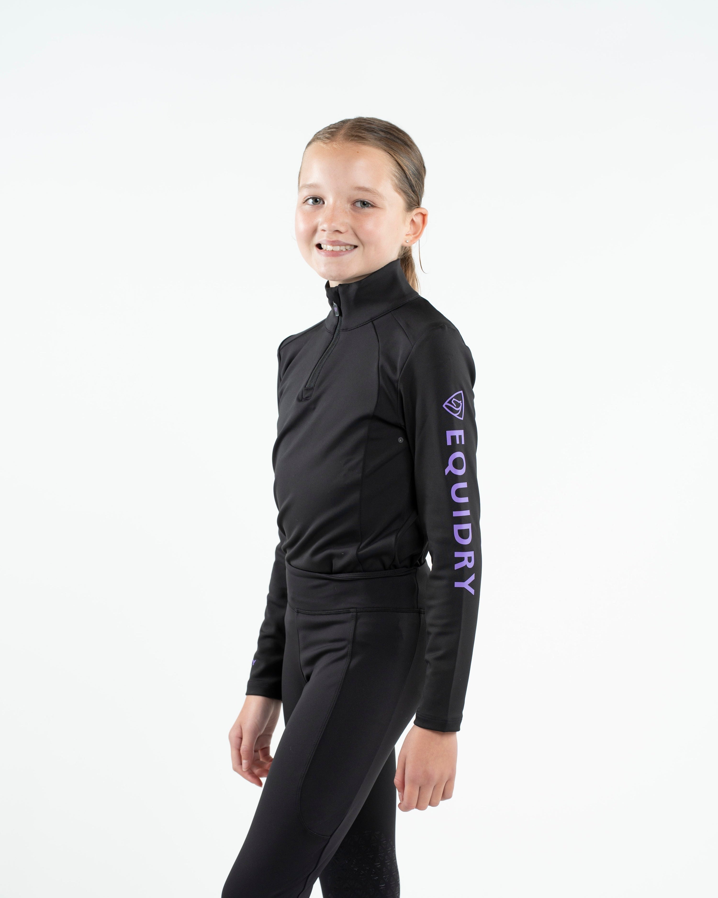 Child Equestrian Base Layer: Black Water Repellent Riding Top with Lilac Logo - EquiDry children's apparel, perfect for young riders.