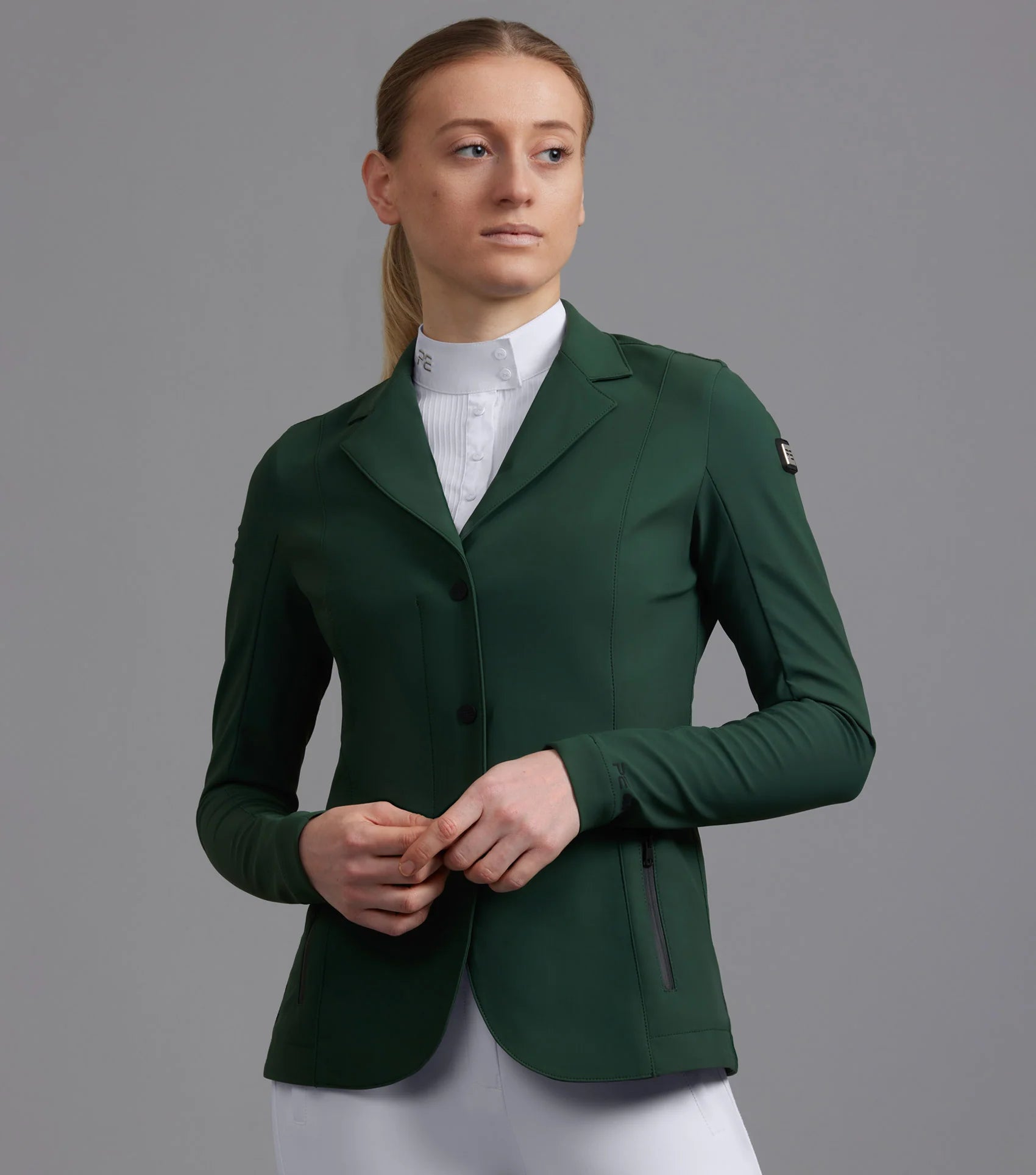 Premier Equine Evinco Ladies Alpine Green Competition Jacket: Stylish equestrian apparel for riders.