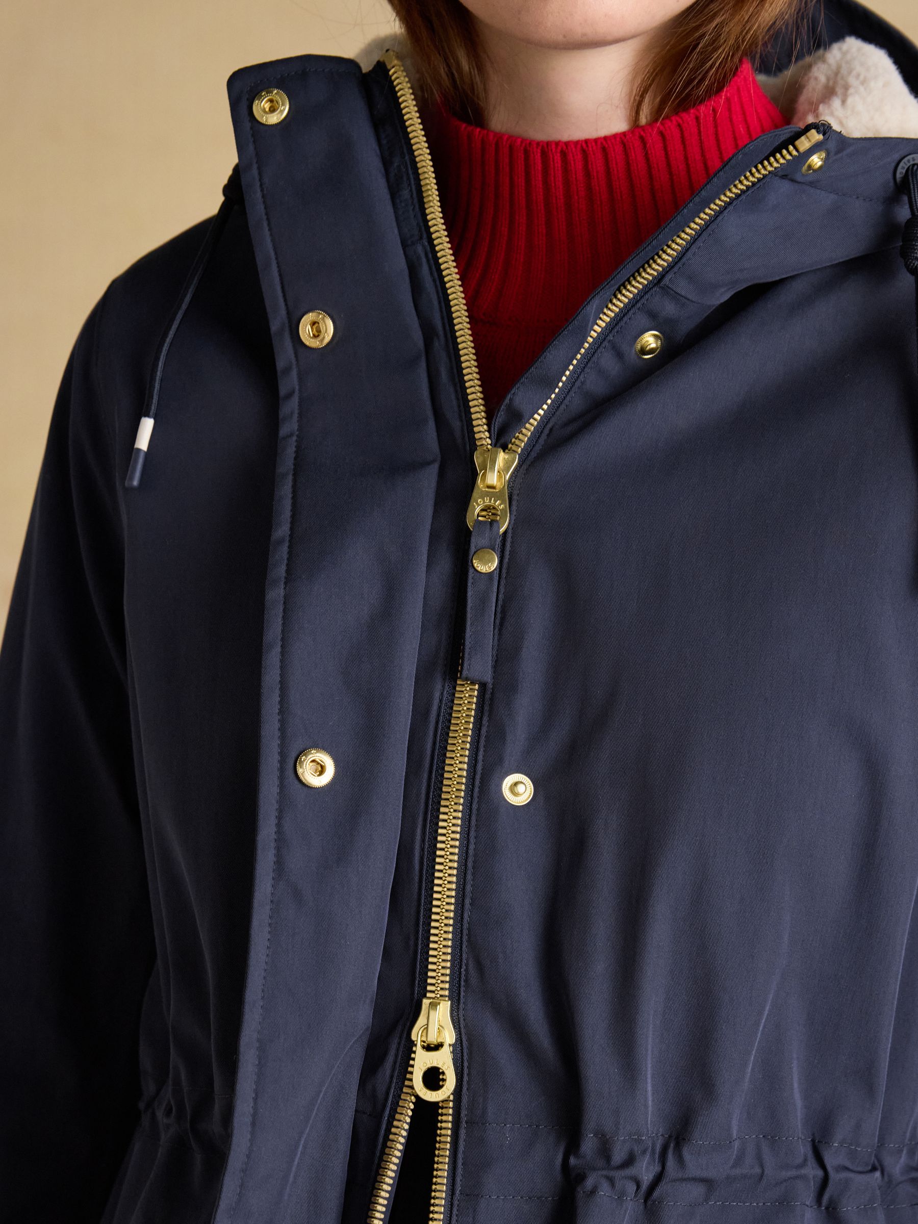 Navy blue Joules fleece-lined waterproof raincoat with hood and gold zipper detail