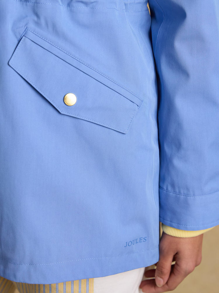 Joules blue hooded waterproof raincoat detail with pocket and branding.