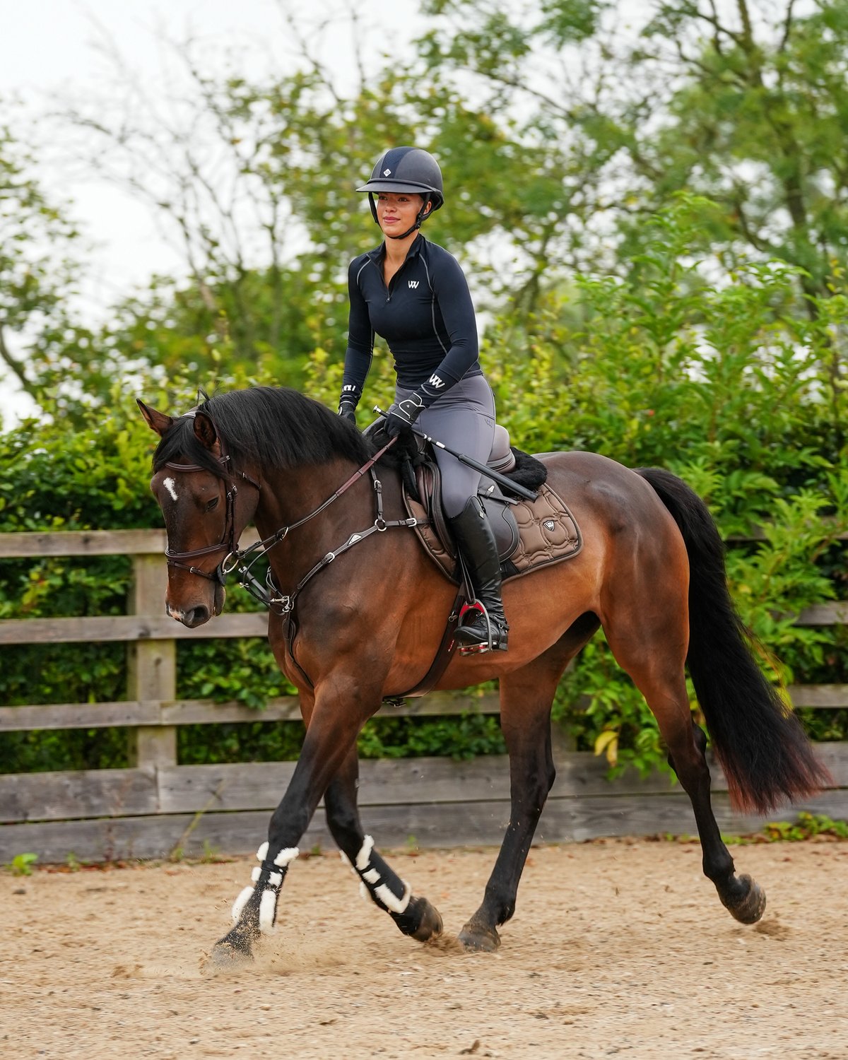 Equestrian: Woman Riding Horse with Woof Wear Vision Elegance Tendon Boots - Black Faux Sheepskin from Equiflair