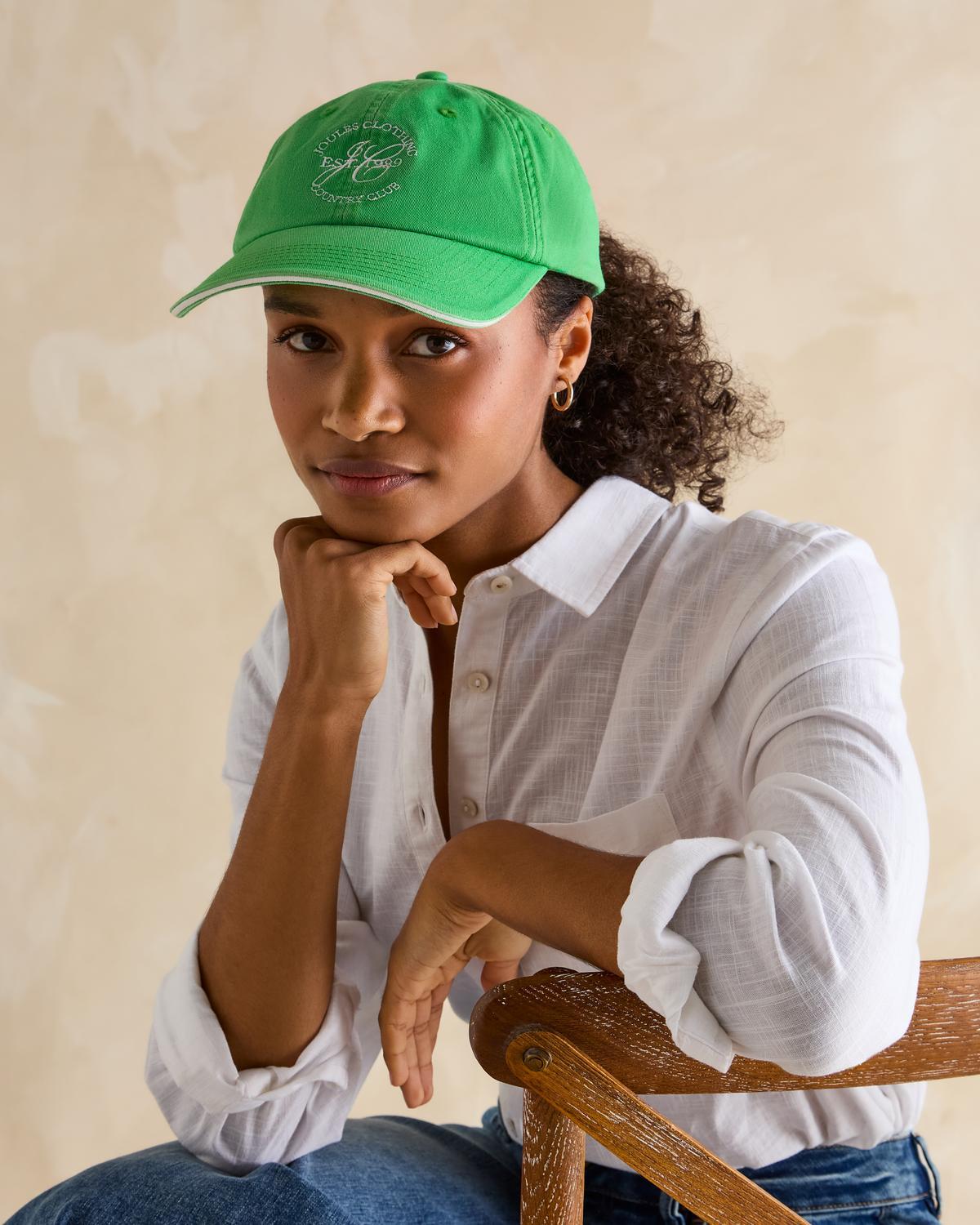 Joules Daley Green Cap: Woman Wearing Baseball Cap with Embroidered Logo