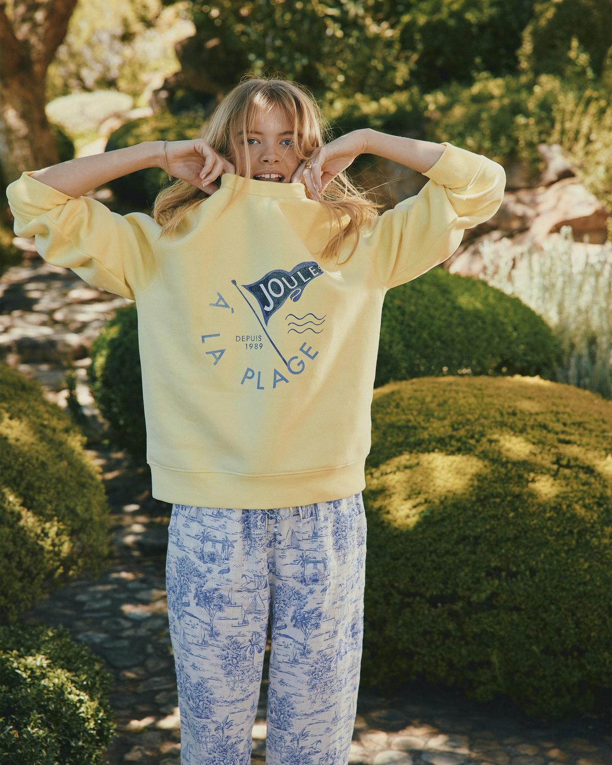 Joules yellow sweatshirt with "A la Plage" graphic & printed pants. Women's fashion from Equiflair.