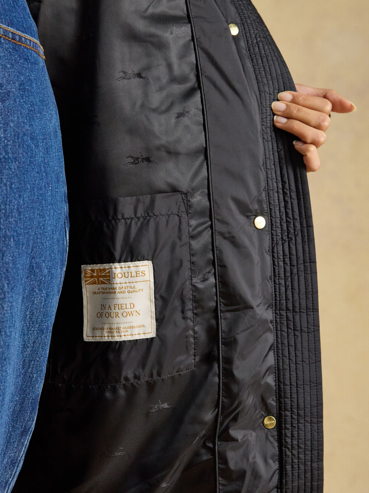 Joules black longline padded coat interior tag with horse pattern lining