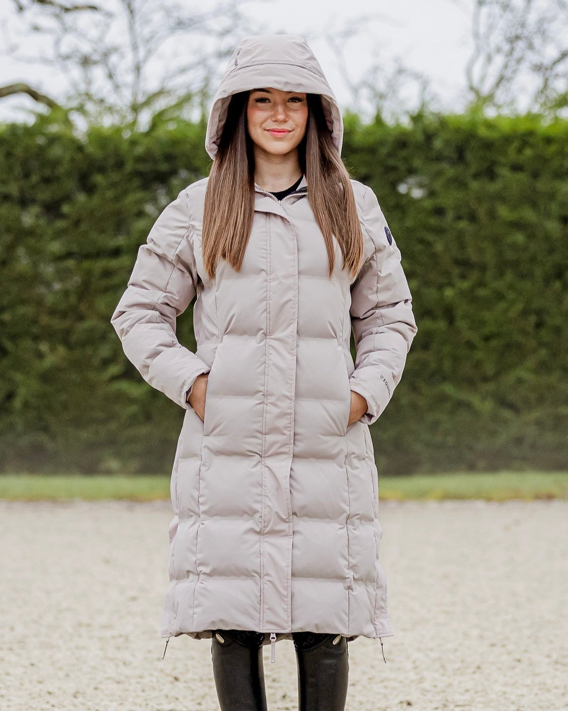 EQUIDRY THORA Waterproof Riding Puffer Coat Women's Sand - Equiflair. Lightweight, warm, and stylish winter equestrian coat with hood.