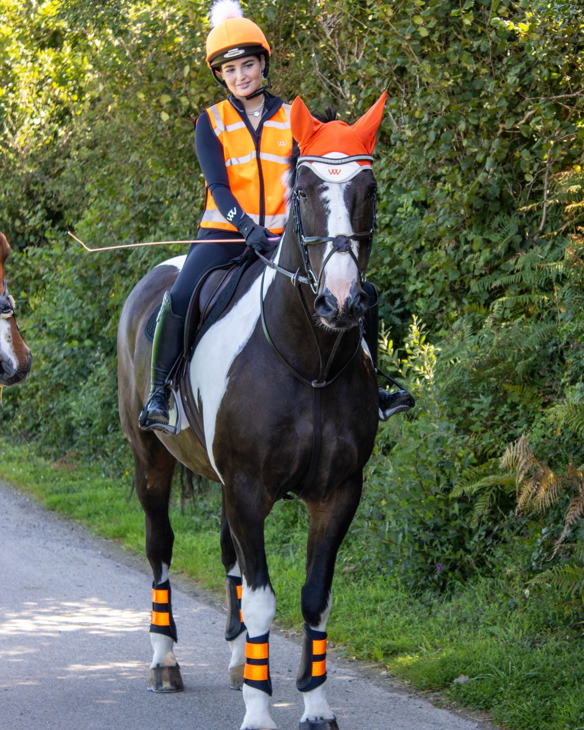 Woof Wear Reflective Club Boot Hi Viz Orange: Horse Riding Safety Gear from Equiflair. Ensuring visibility for equestrian activities.