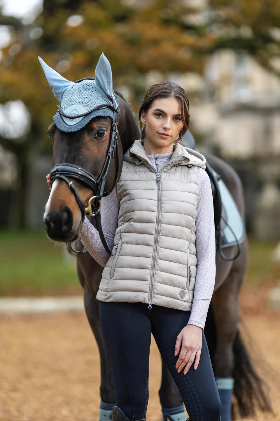 LeMieux Tilly Hooded Puffer Gilet Ash: Equestrian vest from Equiflair. Woman with horse
