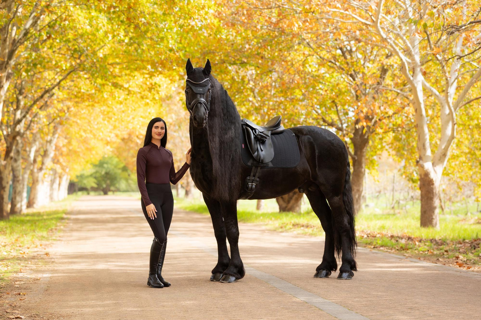 Equestrian Woman with Horse wearing LEMIEUX HEYDEN Base Layer Damson by Equiflair. Stylish horse riding outfit in autumn.