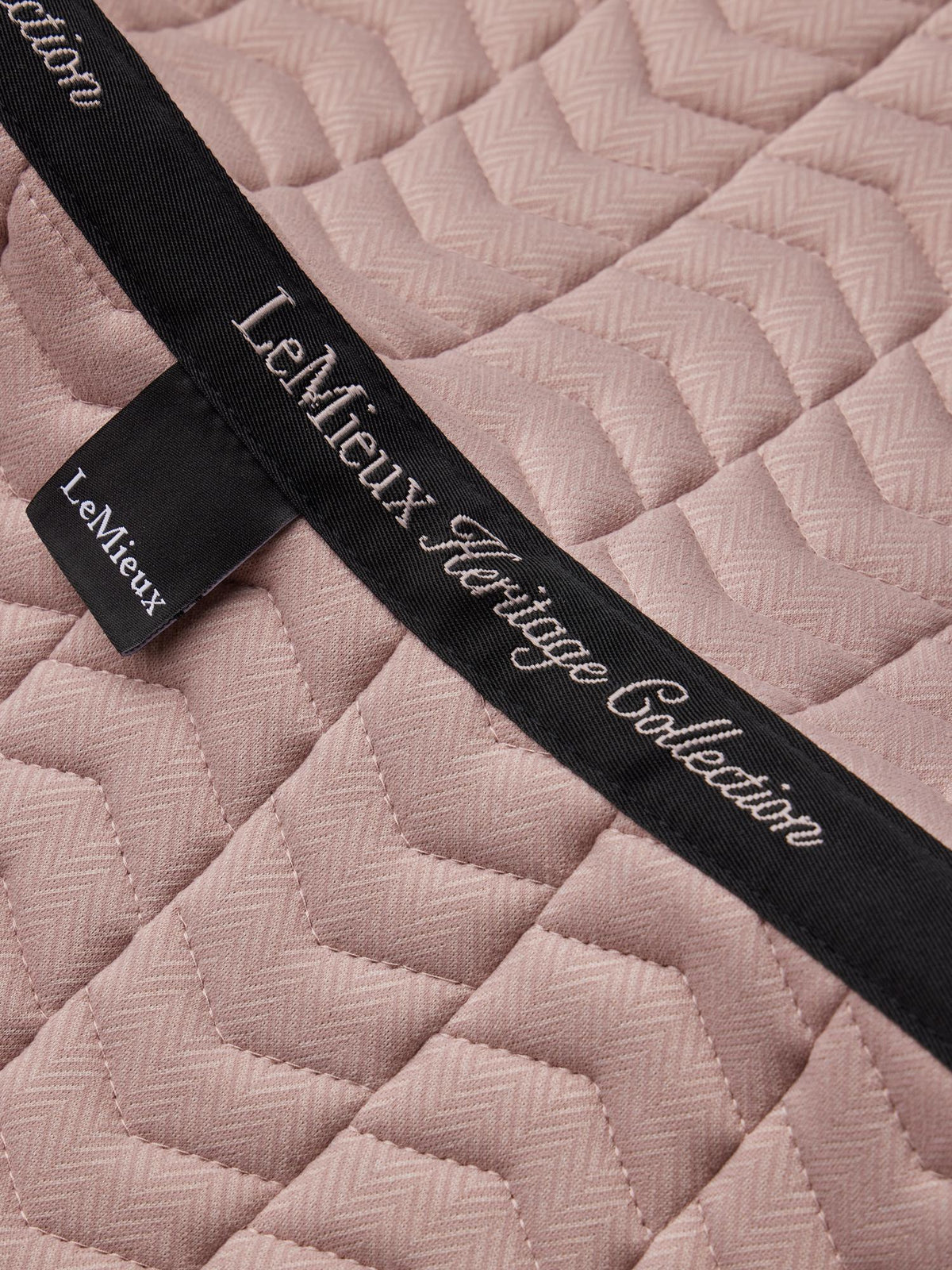 LeMieux Heritage Herringbone Dressage Square in Wild Rose pink with quilted pattern and branding.