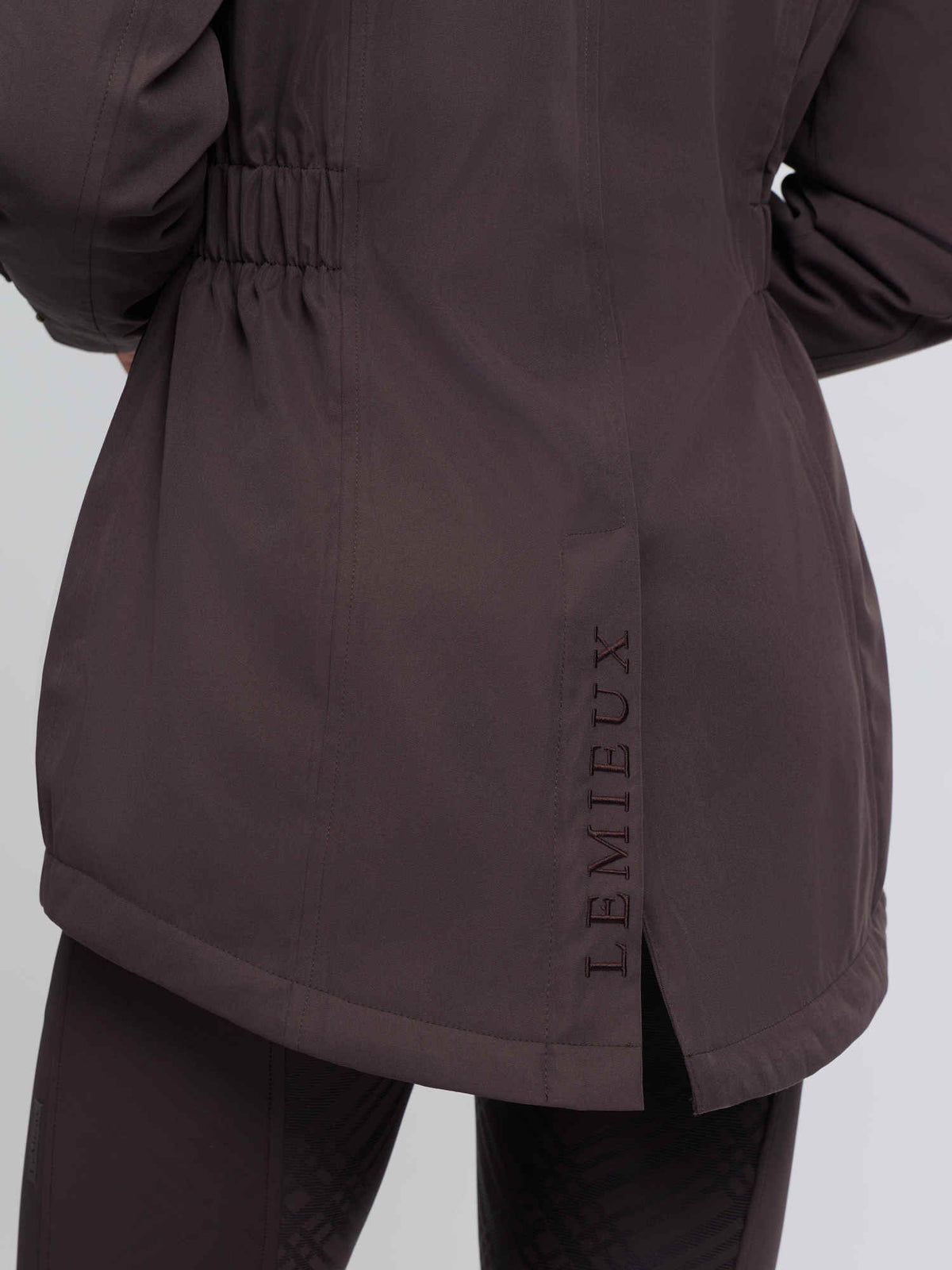 LeMieux cocoa brown waterproof riding coat back with embroidered logo and hem vent