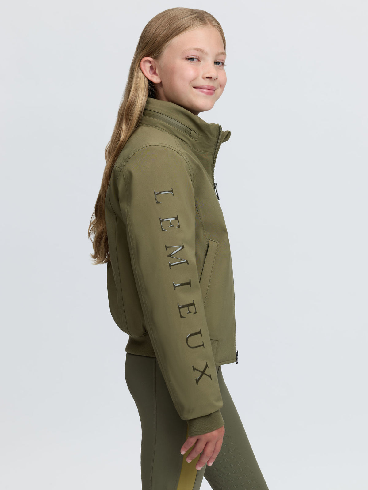 Young girl wearing green Lemieux Clarissa crew jacket and leggings