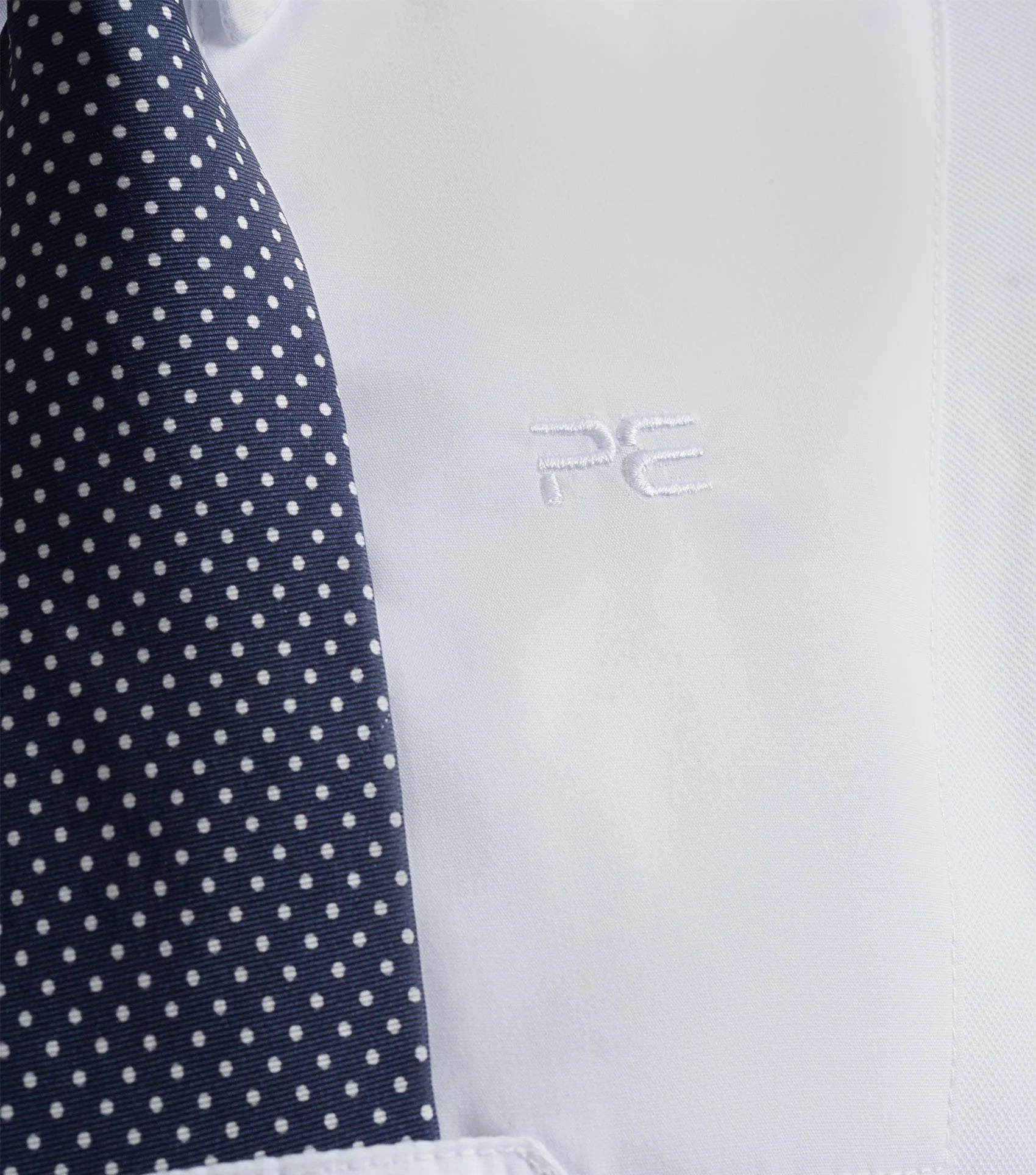 Premier Equine white equestrian short sleeve competition shirt with navy polka dot tie