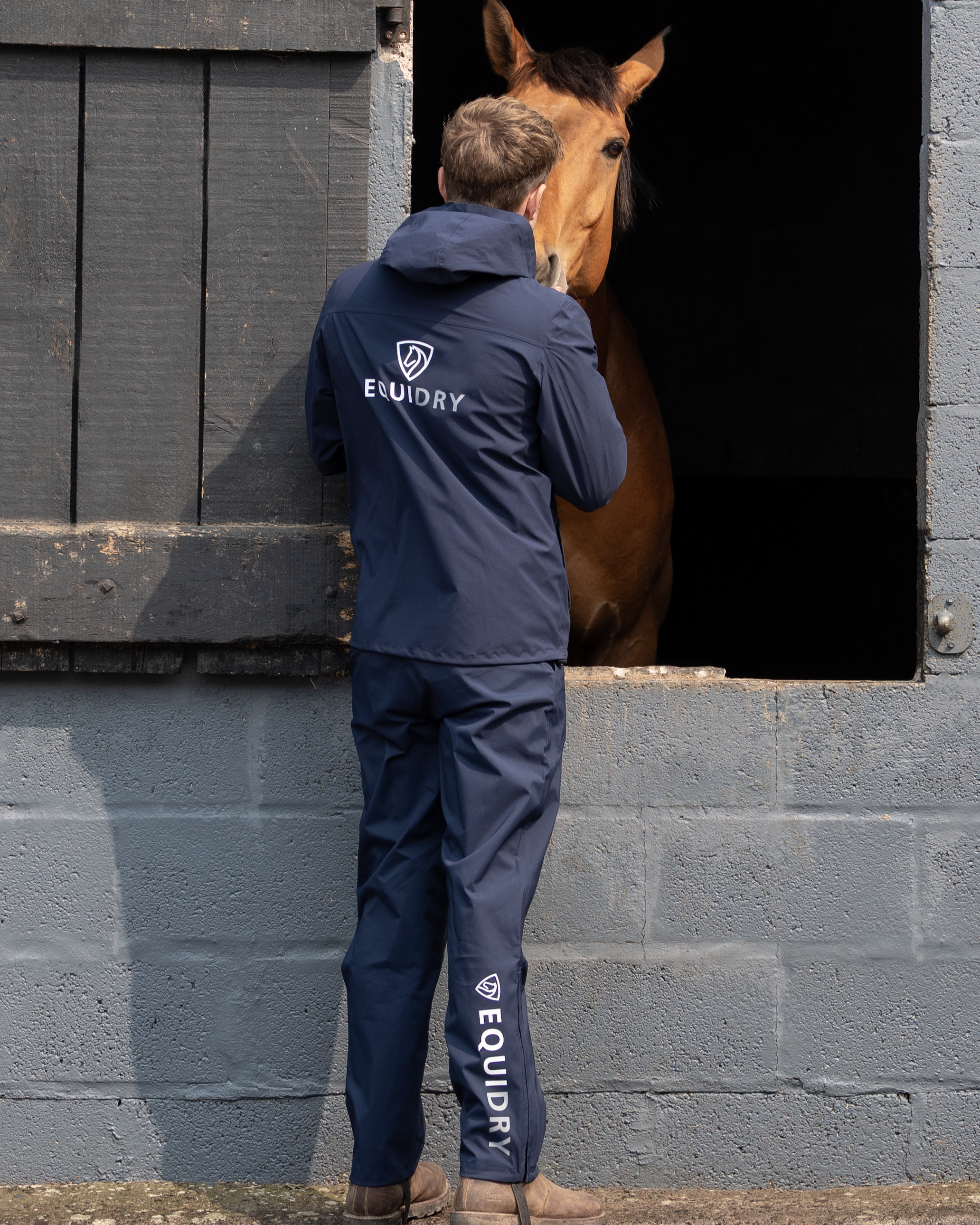 EQUIDRY Nimbus Pack Away Jacket in Navy at Equiflair: Man with Horse in Stable, Lightweight Waterproof Riding Coat
