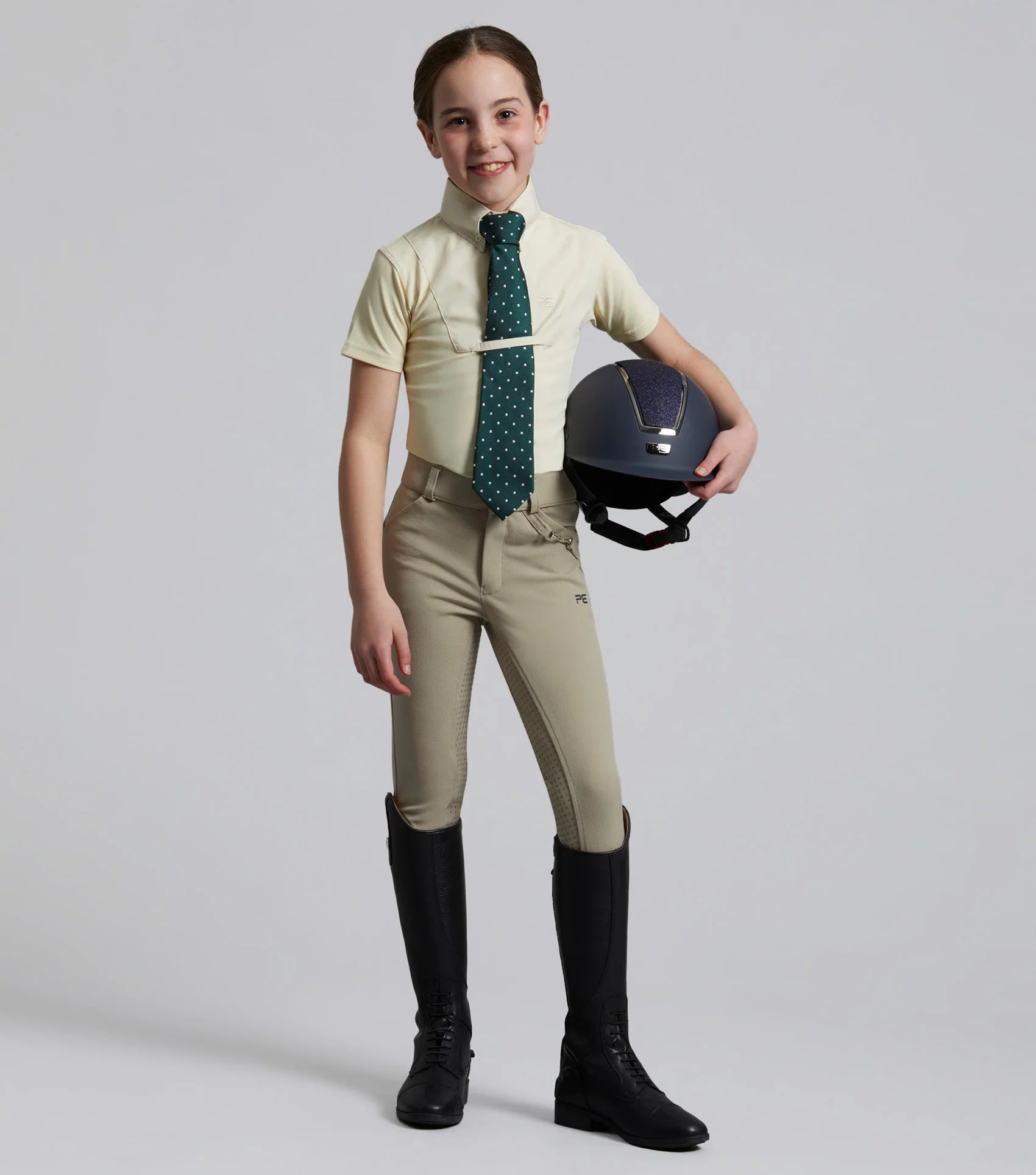 Girl in PREMIER EQUINE Luciana Show Shirt: Equestrian Apparel, Short Sleeve, Vanilla. Riding Outfit. Equiflair Store