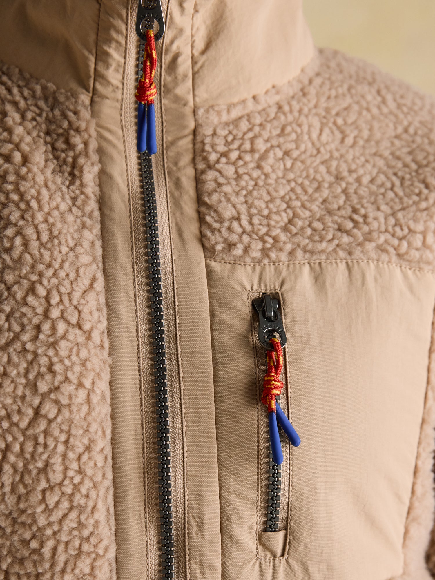 Joules Lottie Neutral Borg Fleece Jacket with Zip Fastening. Cosy icon print borg fleece details with high collar & zipped pockets.